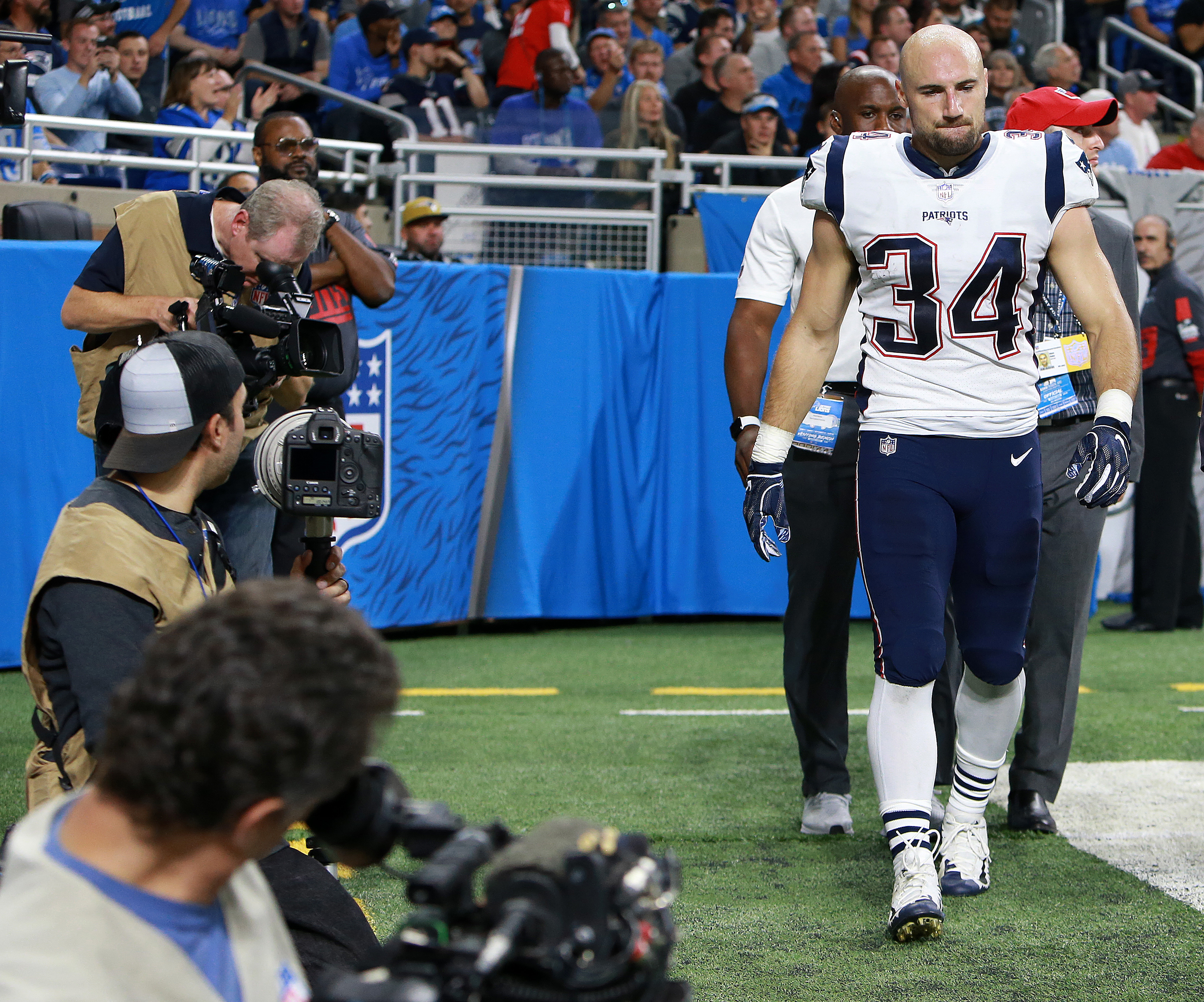 Rex Burkhead heads for the locker room in the second half after suffering a neck injury.
