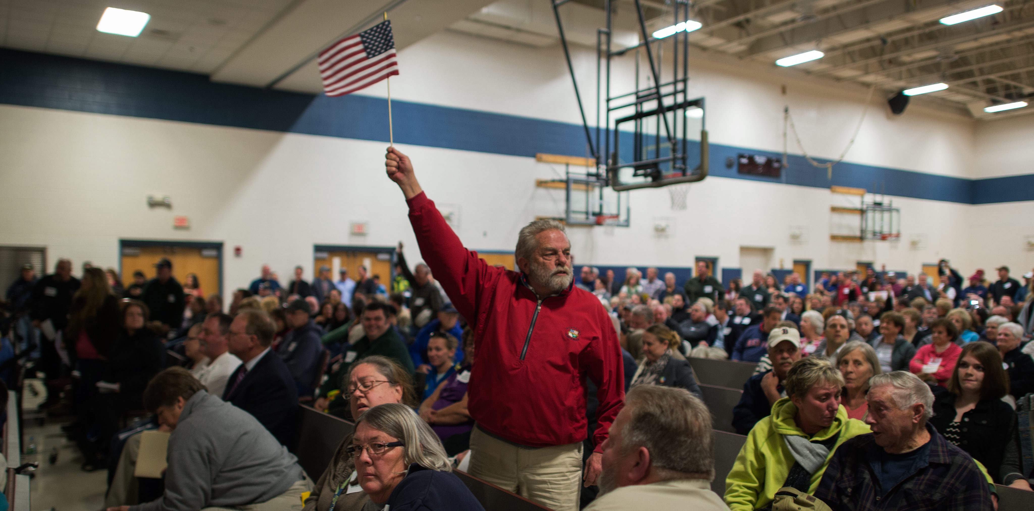 A resident waved a flag at the hearing.