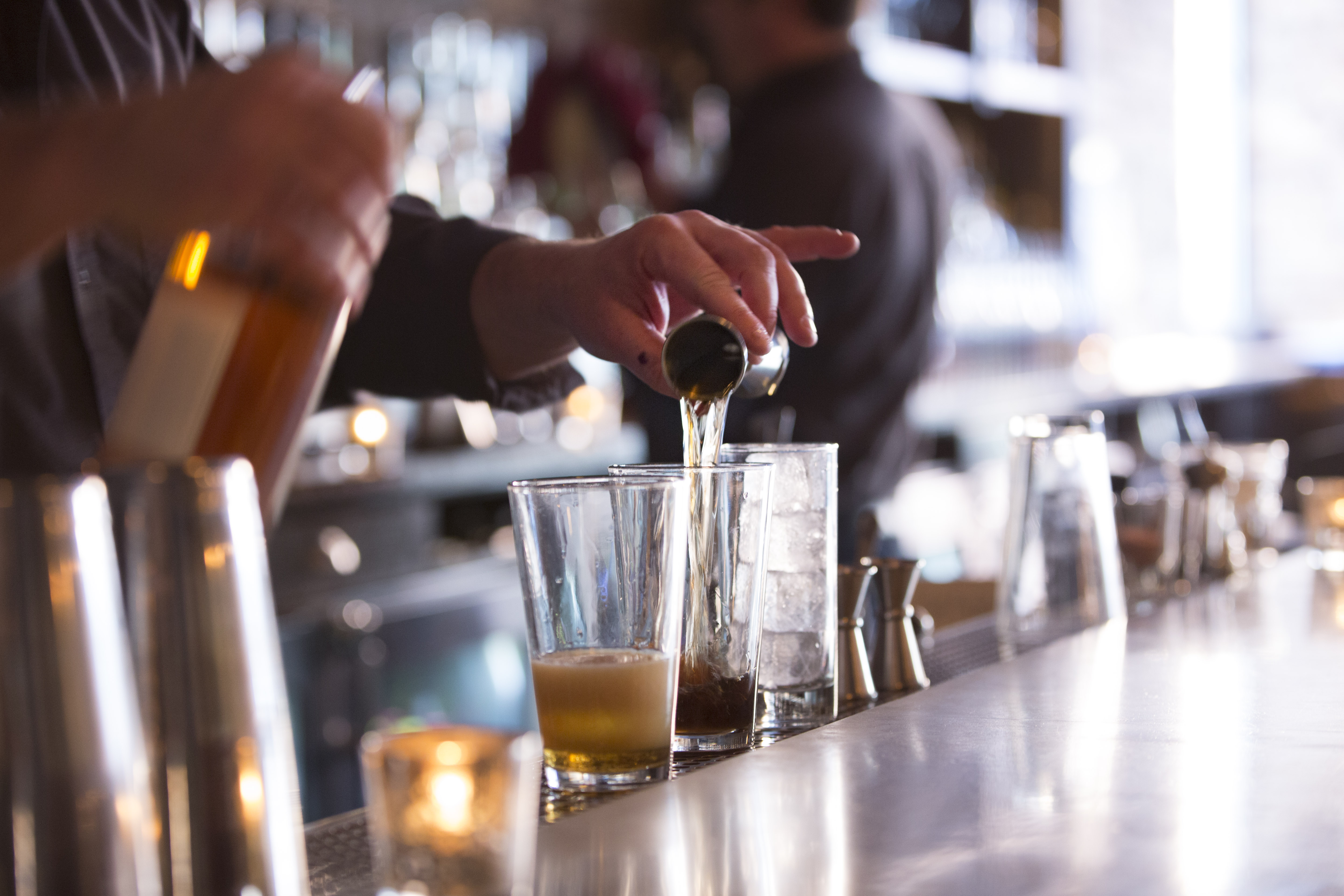 A bartender prepares drinks at Barrel House American Bar in Beverly.
