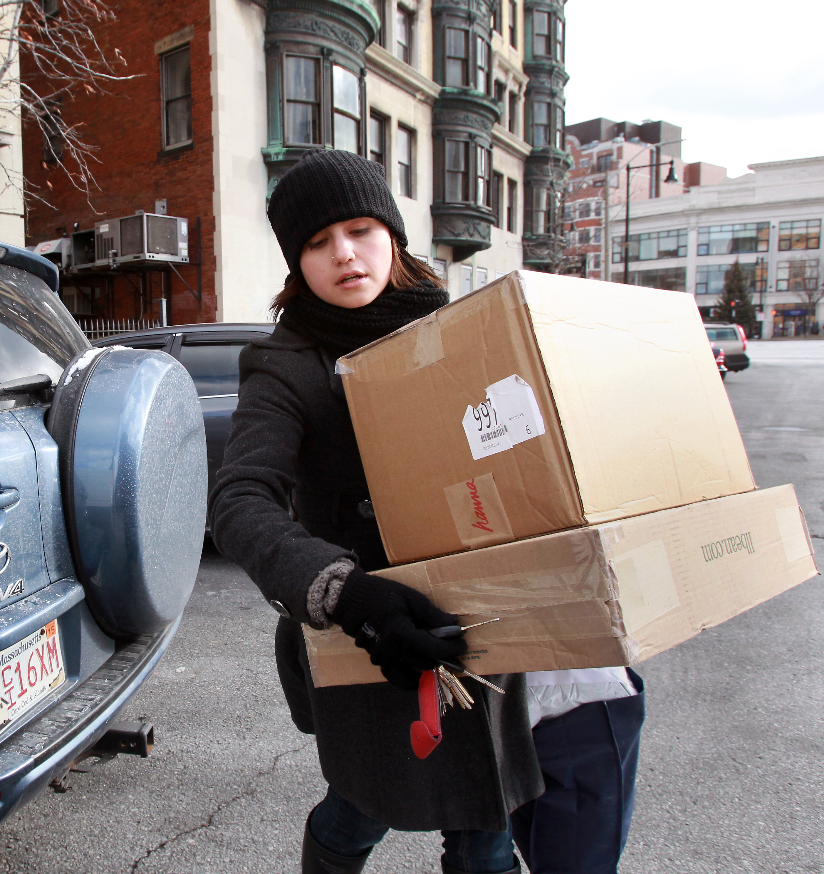 Personal concierge Kristin Cantu takes clients’ packages to the Post Office at Kenmore Square. She said the boxes contained Christmas gifts that were being returned.
