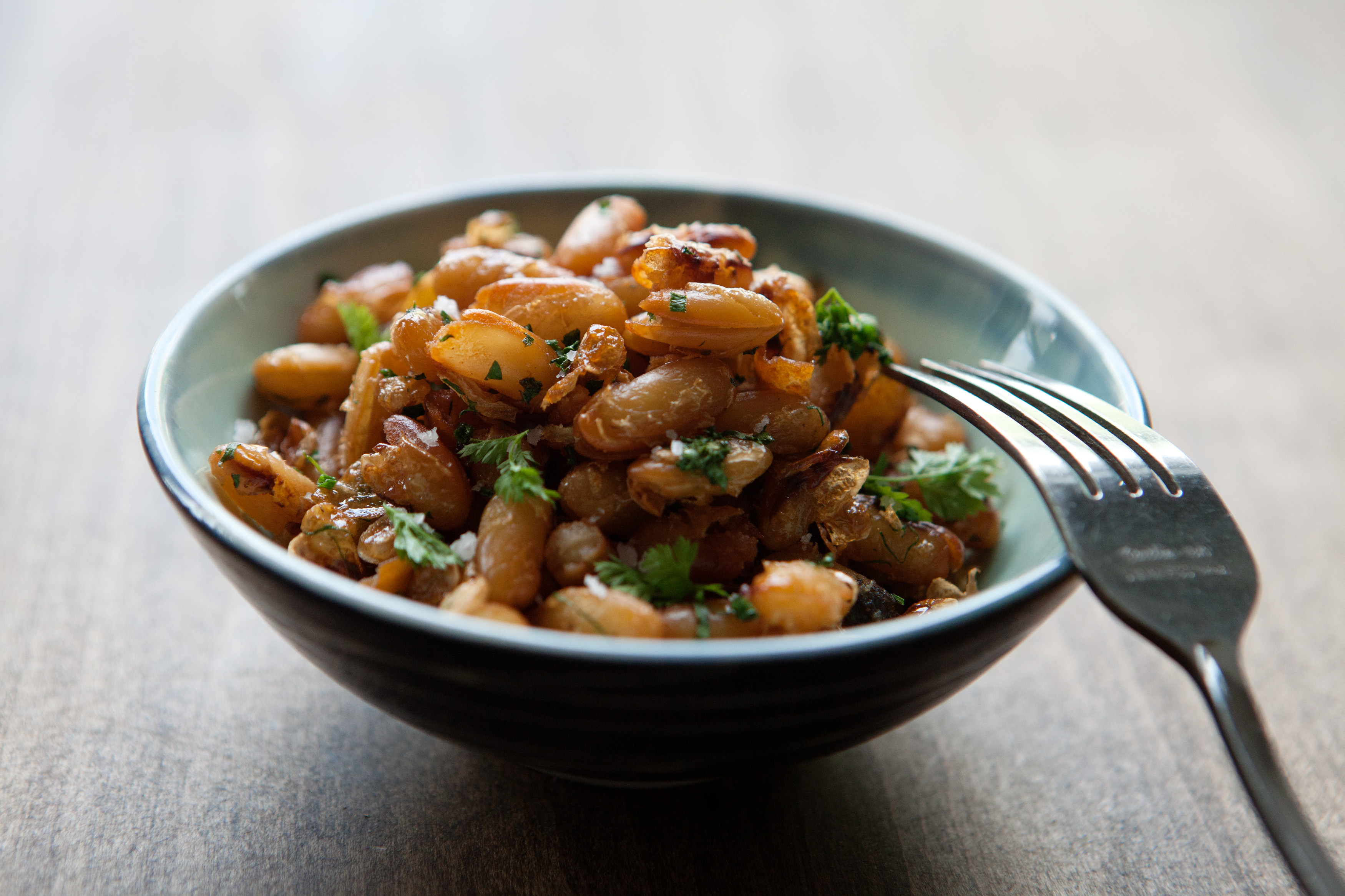 Fried soldier beans in a small dish.