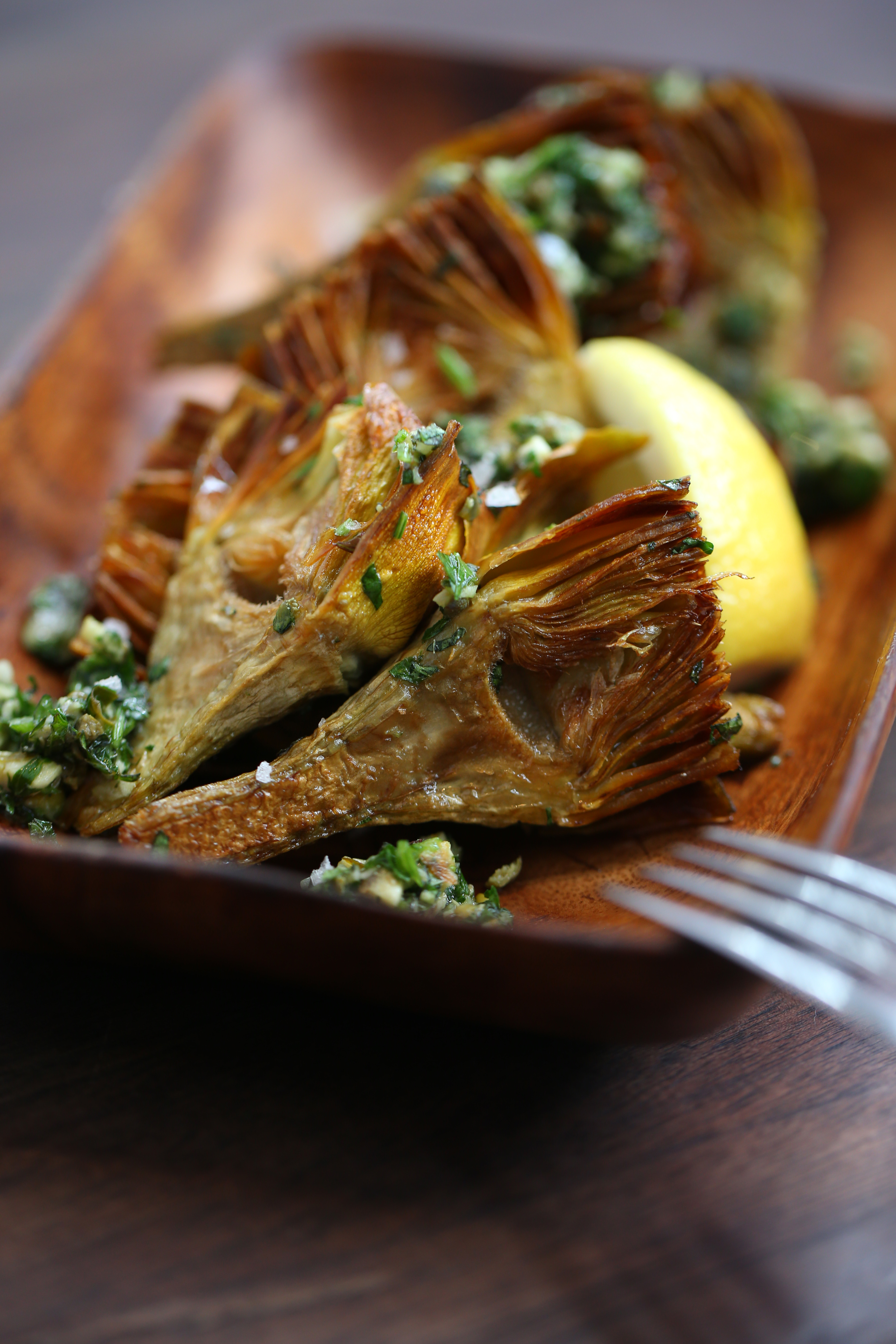 The braised artichokes starter includes anchovies and capers.