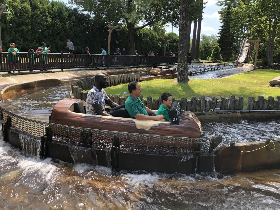 It was a bit of a squeeze, but Tacko Fall (left) rode the log ride at Canobie Lake with Celtics co-owner Steve Pagliuca and a young guest.
