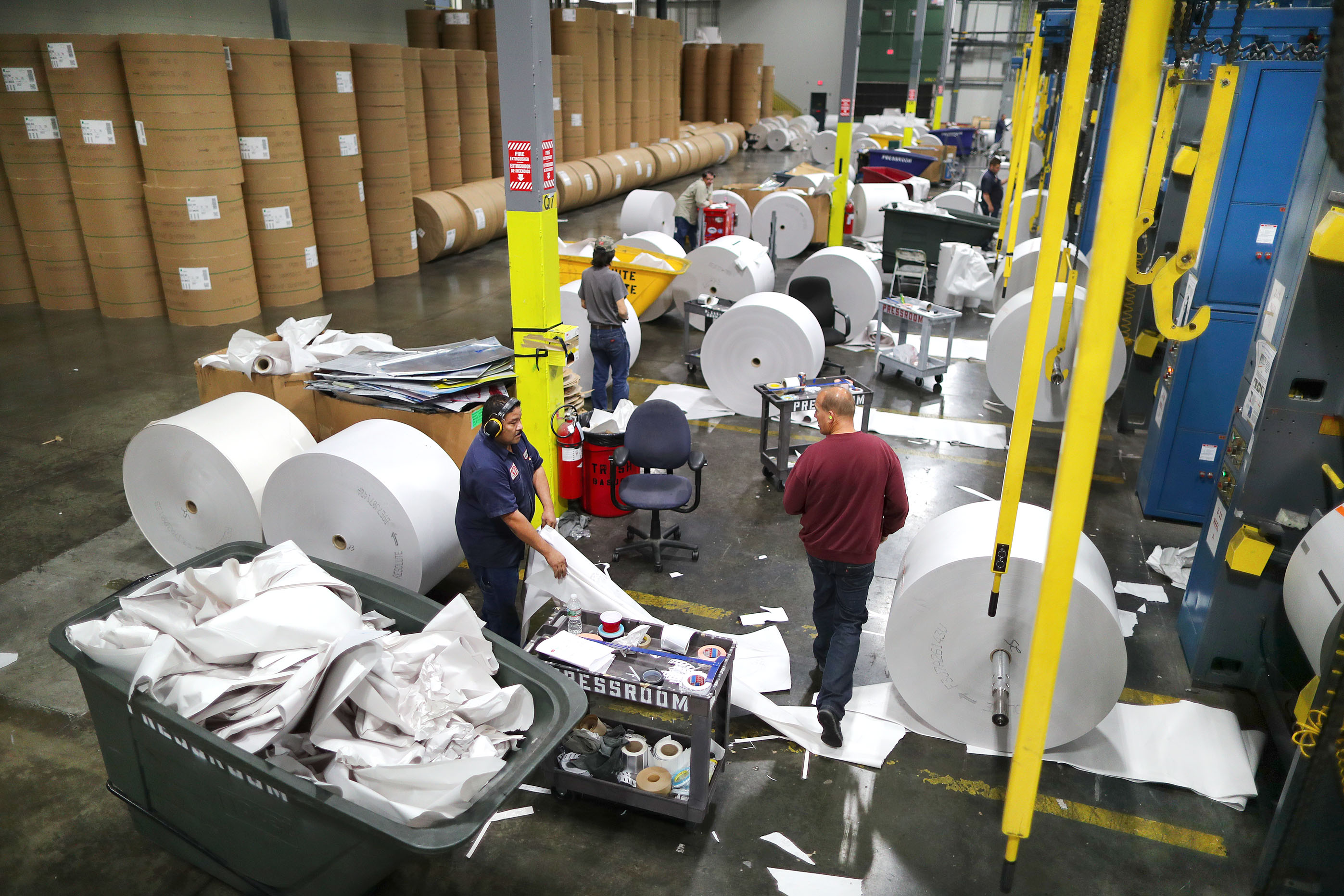 Huge rolls of blank paper were in position to be hoisted onto the presses.