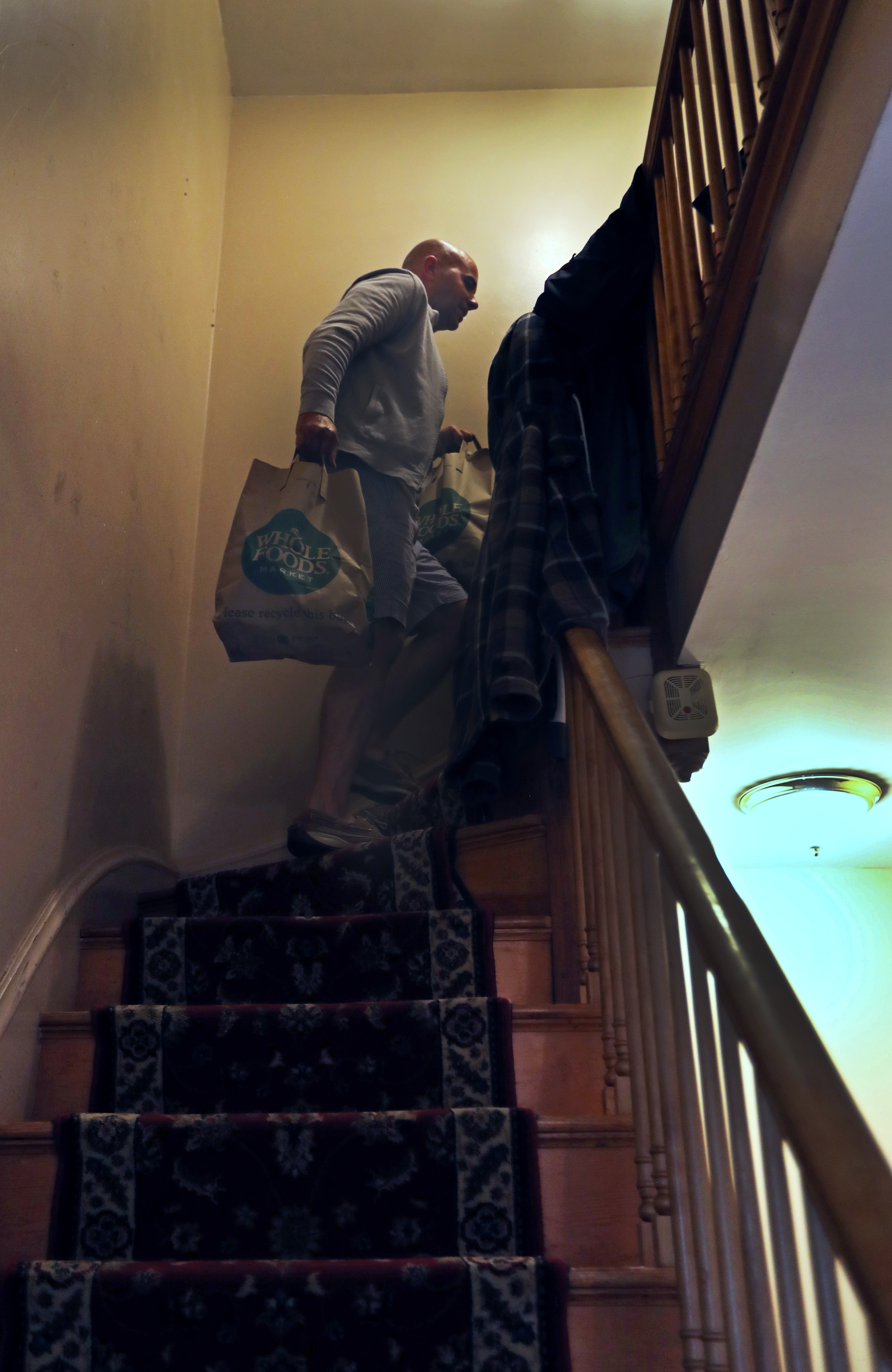 Carson walked up a staircase to make a delivery.