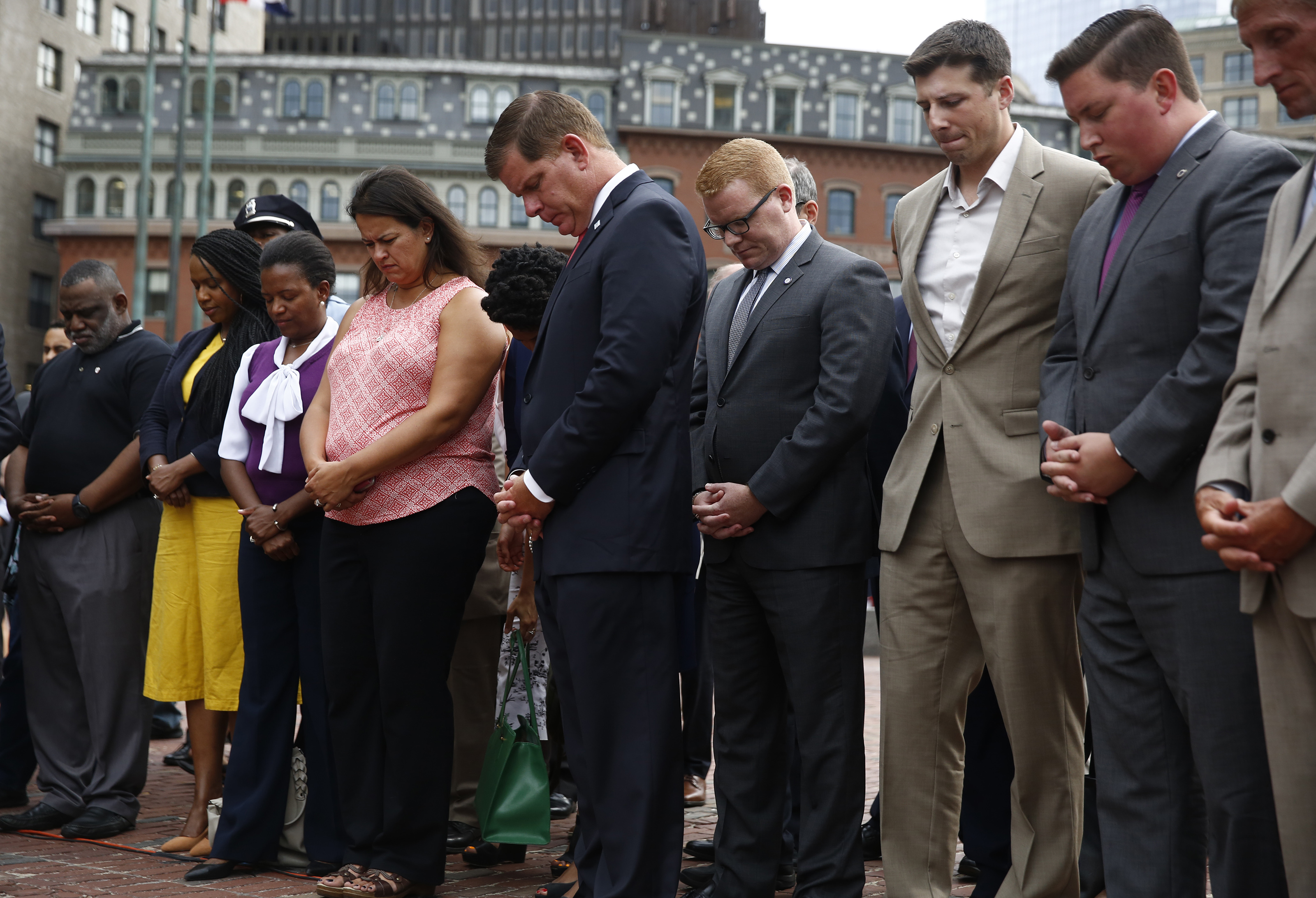Mayor Martin J. Walsh (center) joined others in prayer for the victims in Charlottesville, Va., at City Hall Plaza Monday.