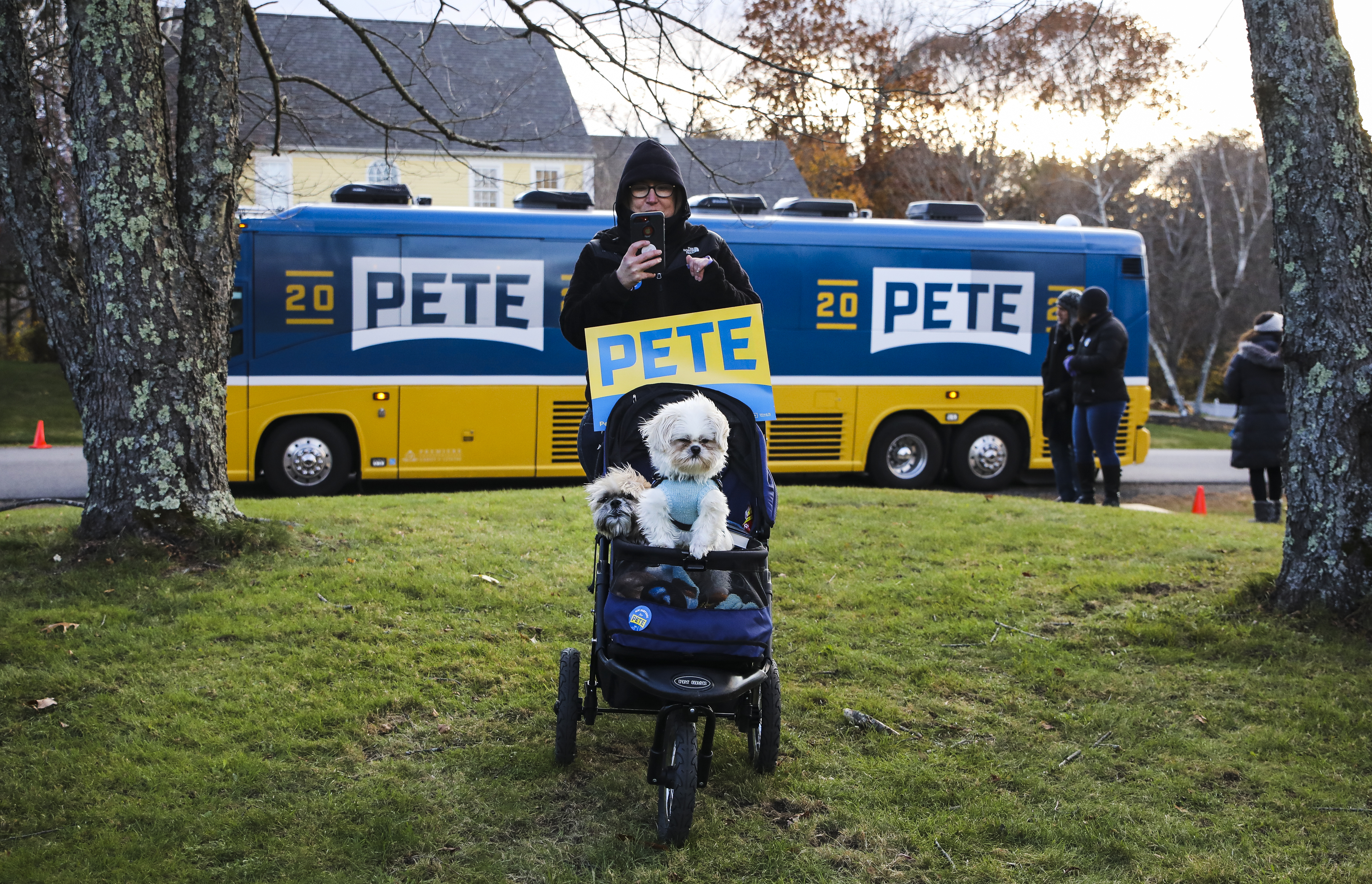 Gina Millwood and her dogs Cooper and Spencer waited for Pete Buttigieg after the mayor wrapped up his rally in a packed barn party, hosted by fellow supporters in Stratham, N.H.