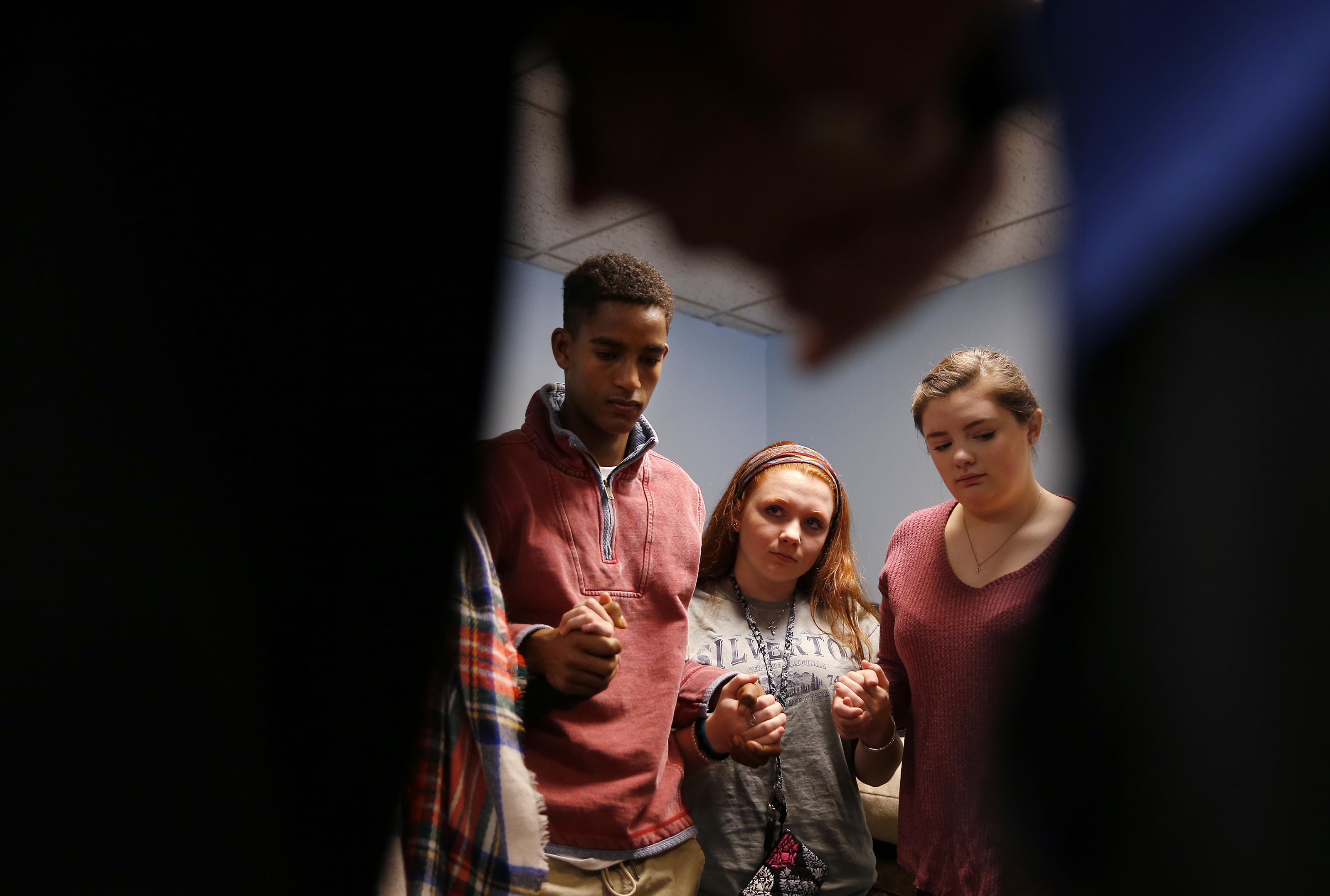 Ailin Oberlies, 15, of Stow, Valerie Fallica, 16, of Acton, and Caroline Bunnell, 17, of Stow prayed with Jim Flanagan for those touched by depression and suicide.