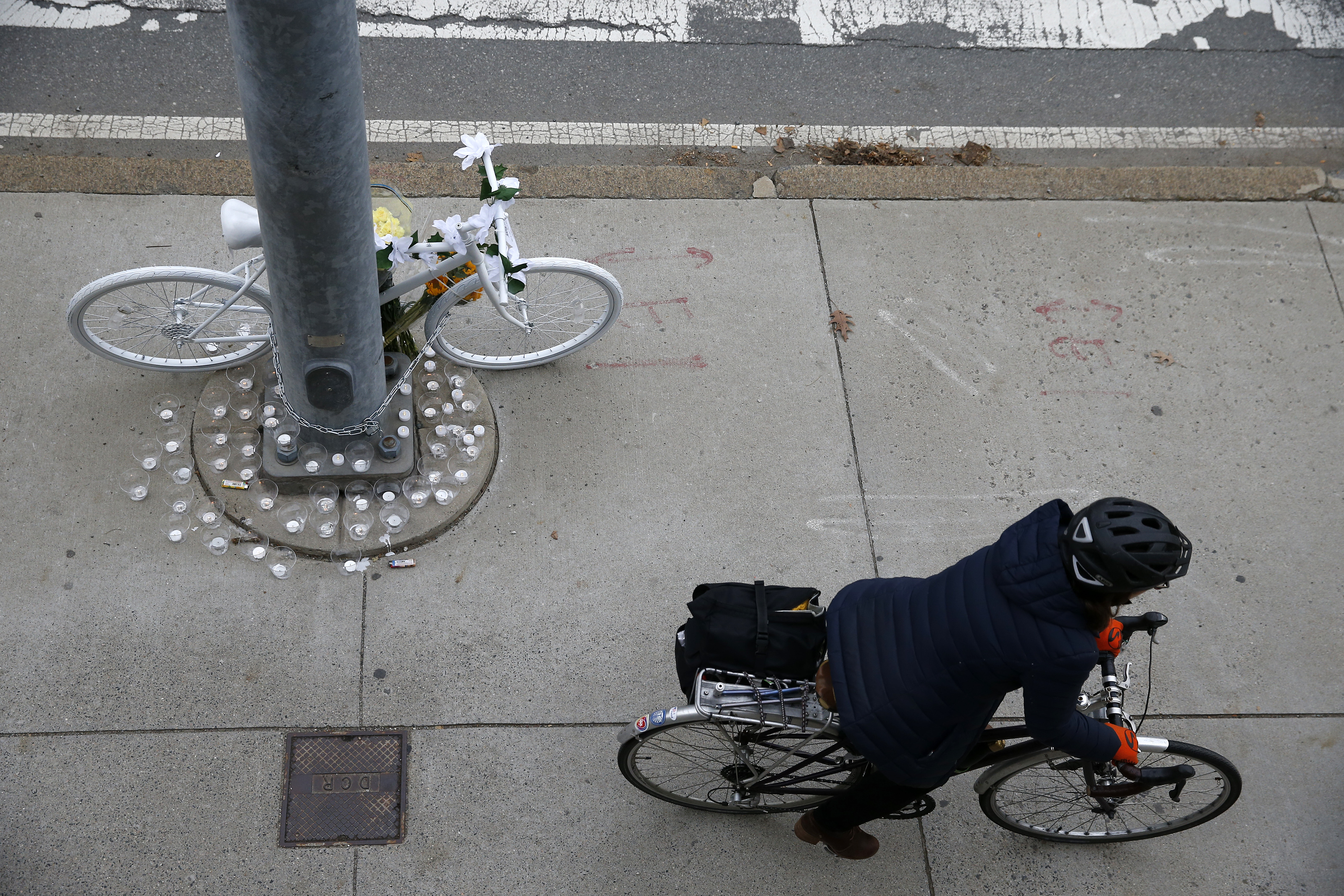A bicyclist passed the ghost bike placed in memory of Jin near the Museum of Science.