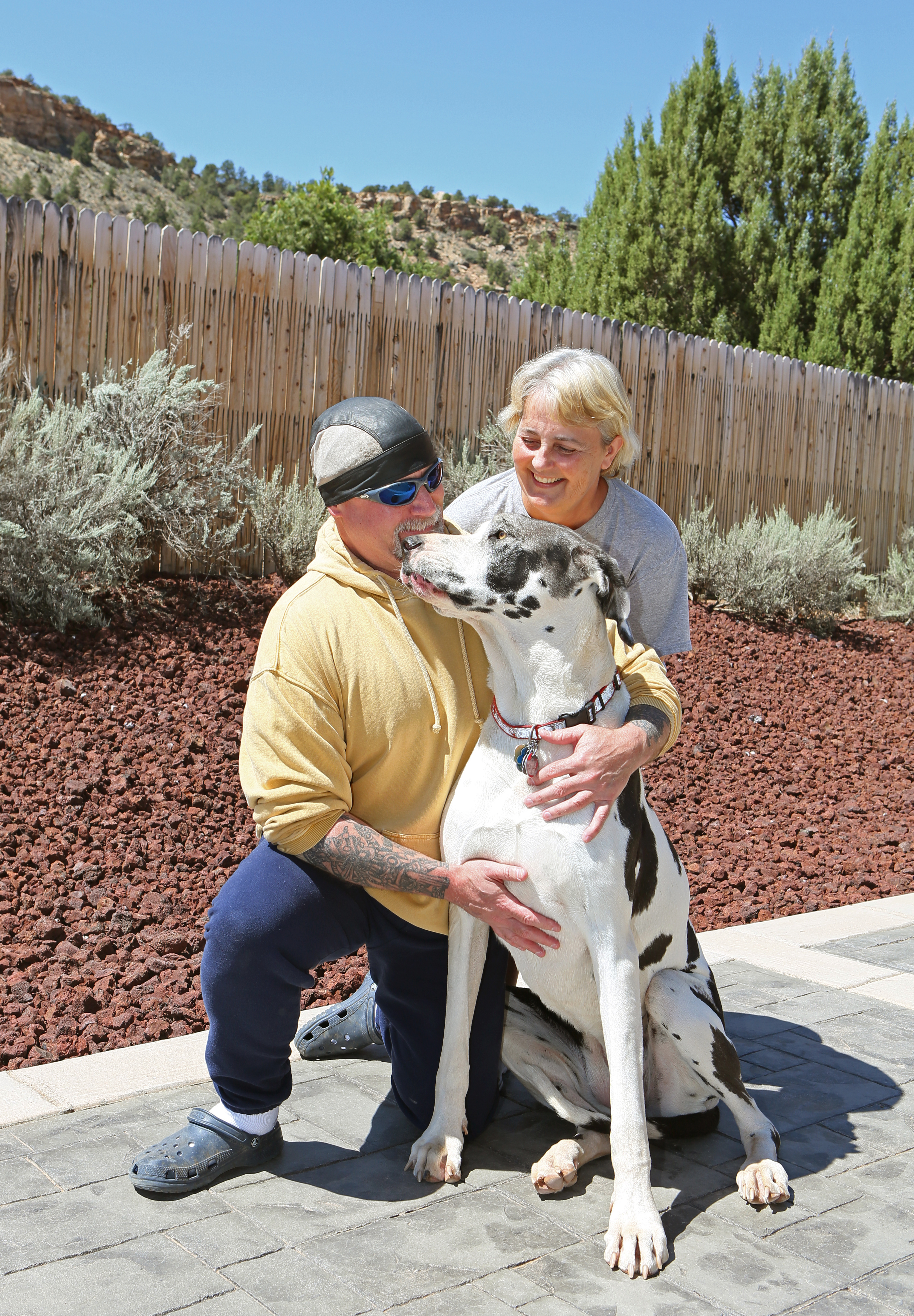 John Moore shared a moment with his wife, Cathy, and their dog outside their Utah home on Thursday.