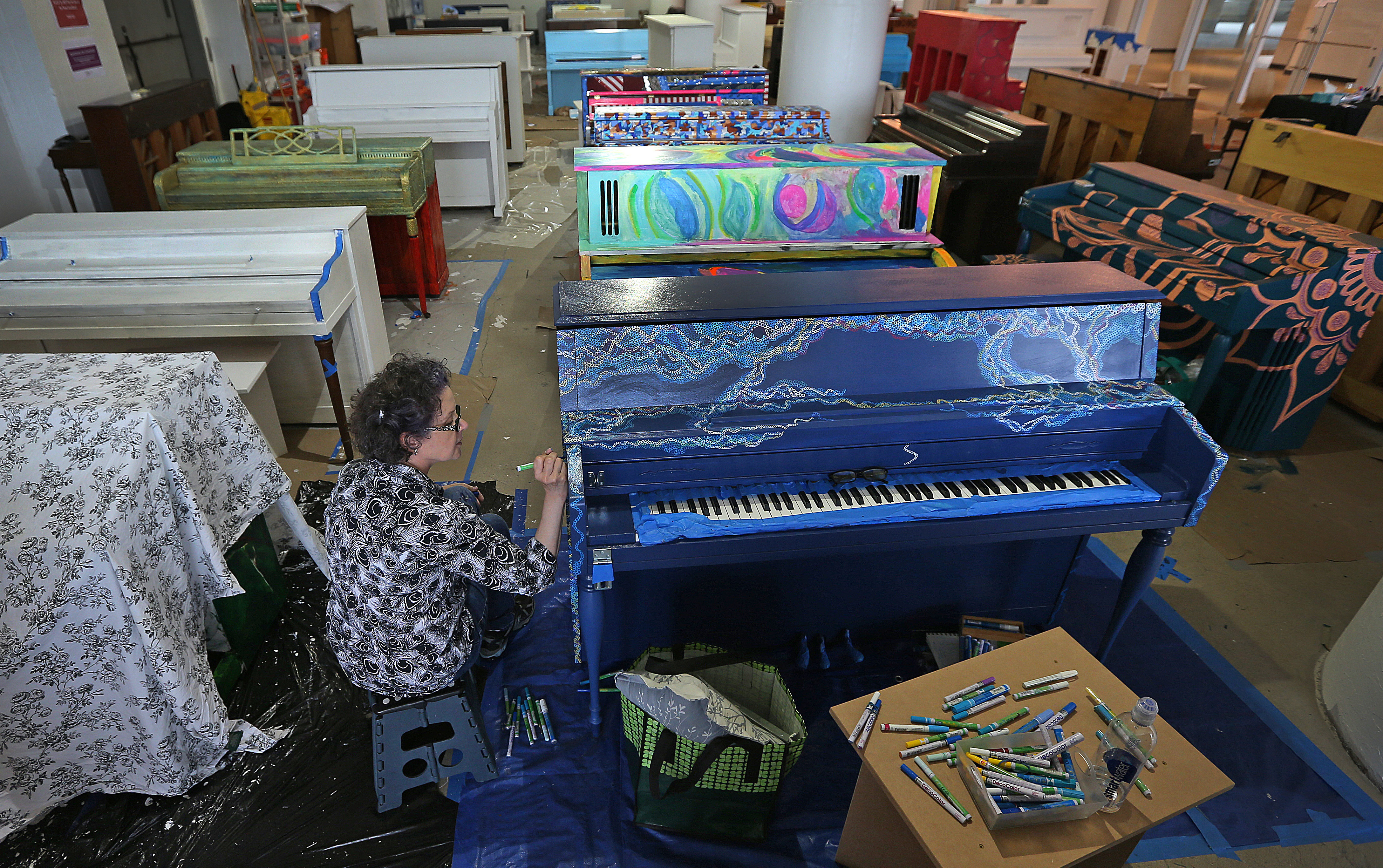 Artist Claudia Ravaschiere of Boston worked on one of the pianos that will be installed in public spaces around Boston.
