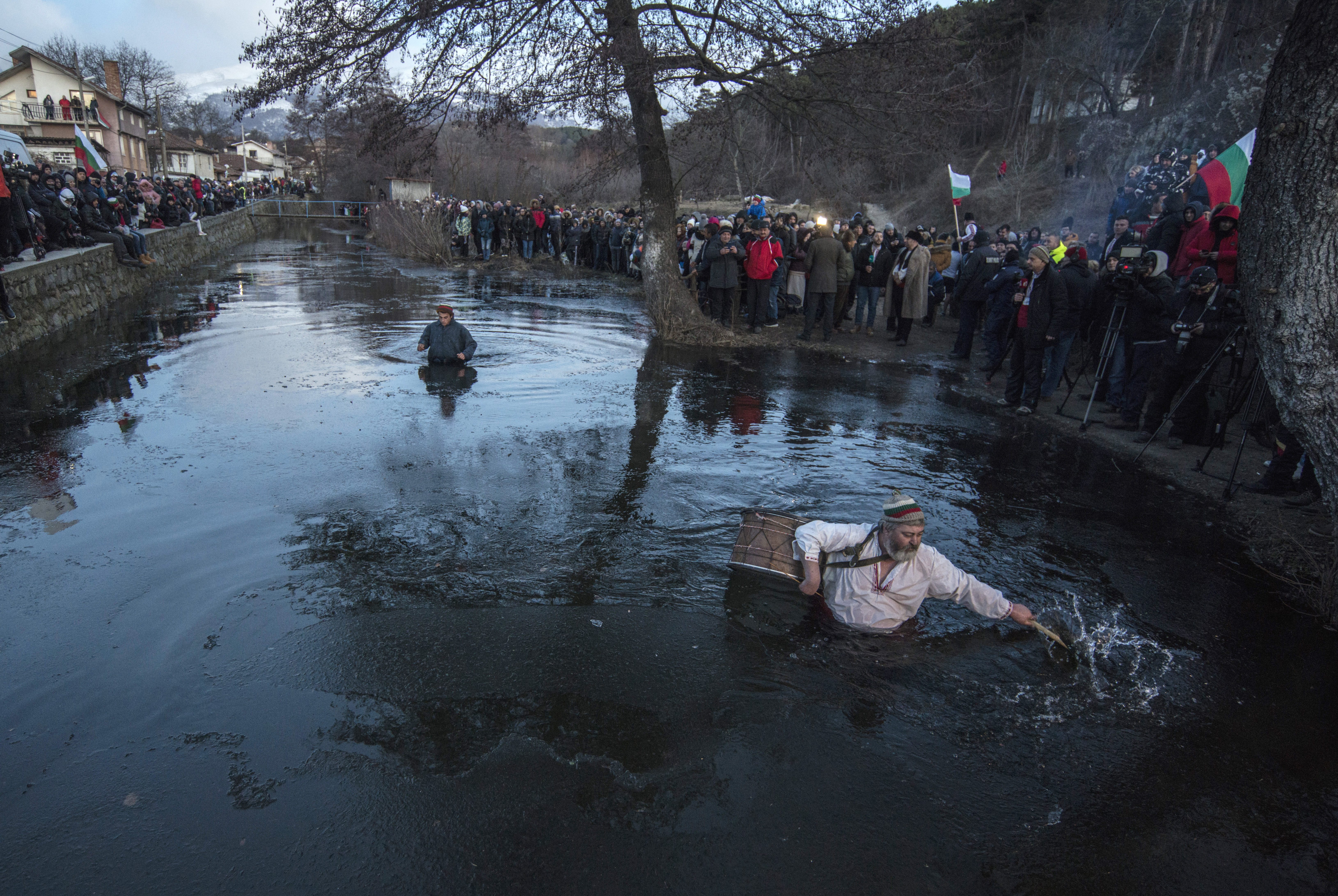 A drummer broke ice prior to the Epiphany ritual, in Kalofer, Bulgaria.