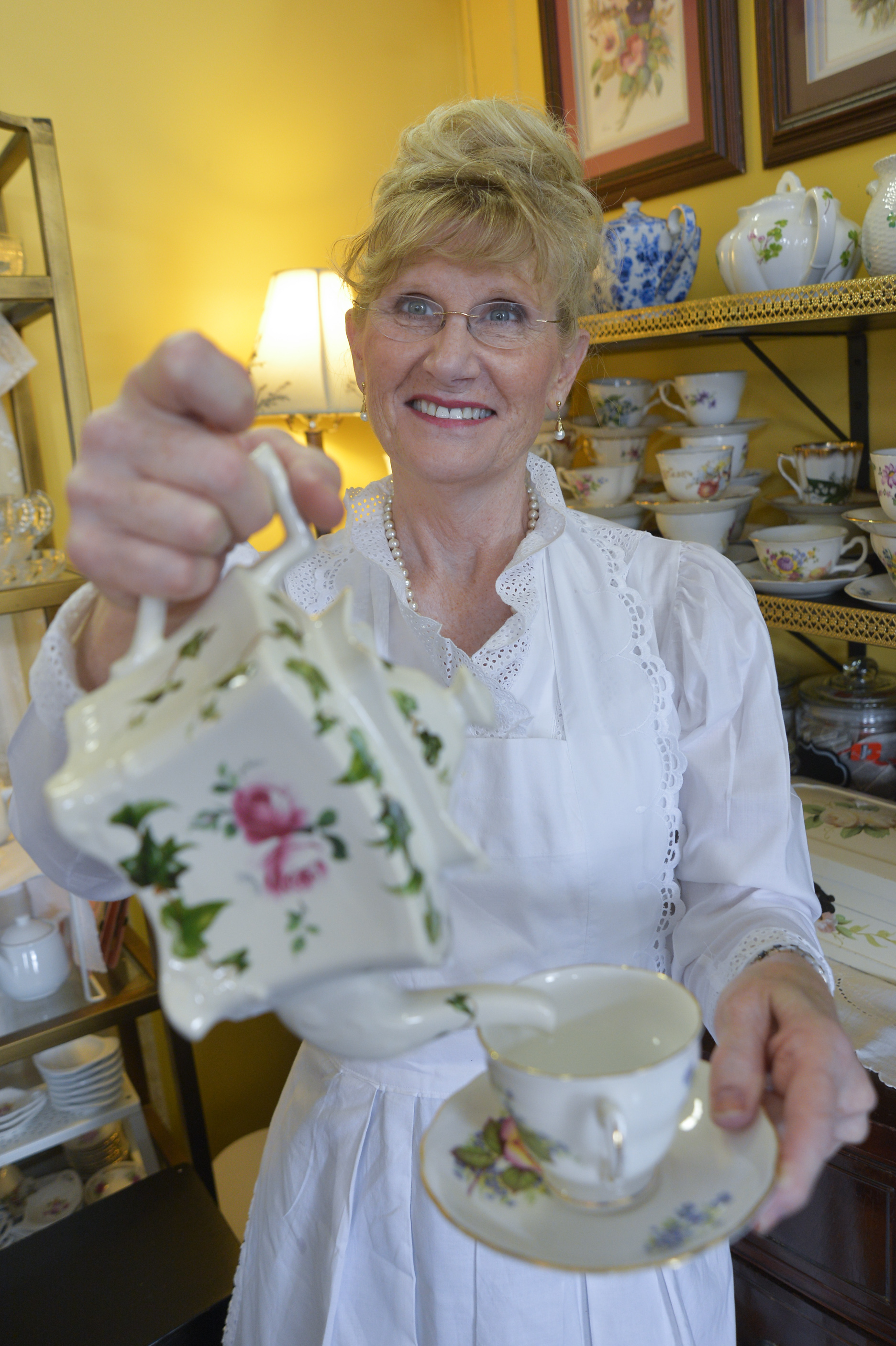 Would you like a refill? Suzanne Richardson pours steaming water from a teapot in her Lowell tearoom.