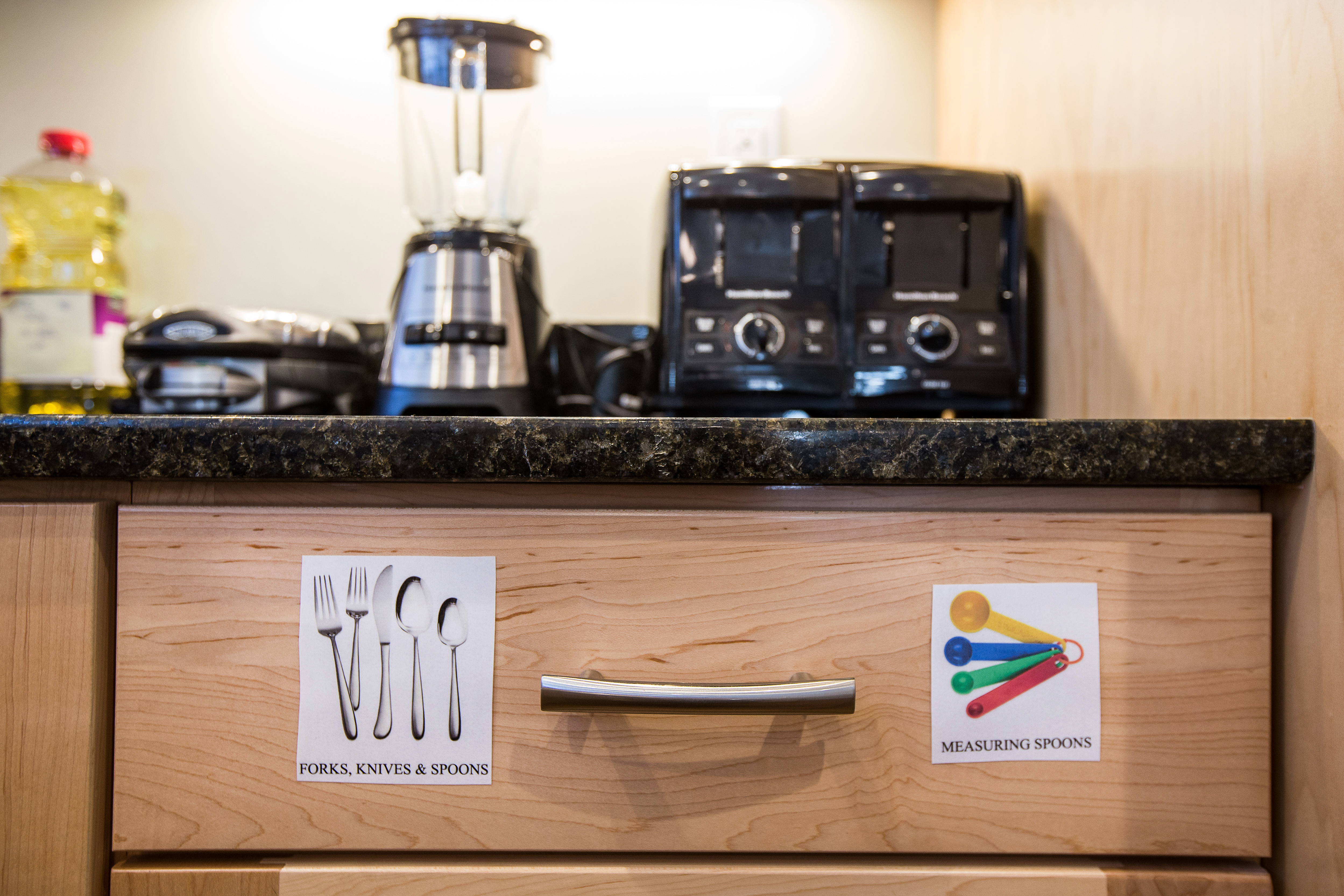 Labeled kitchen drawers in D.J.’s residence.
