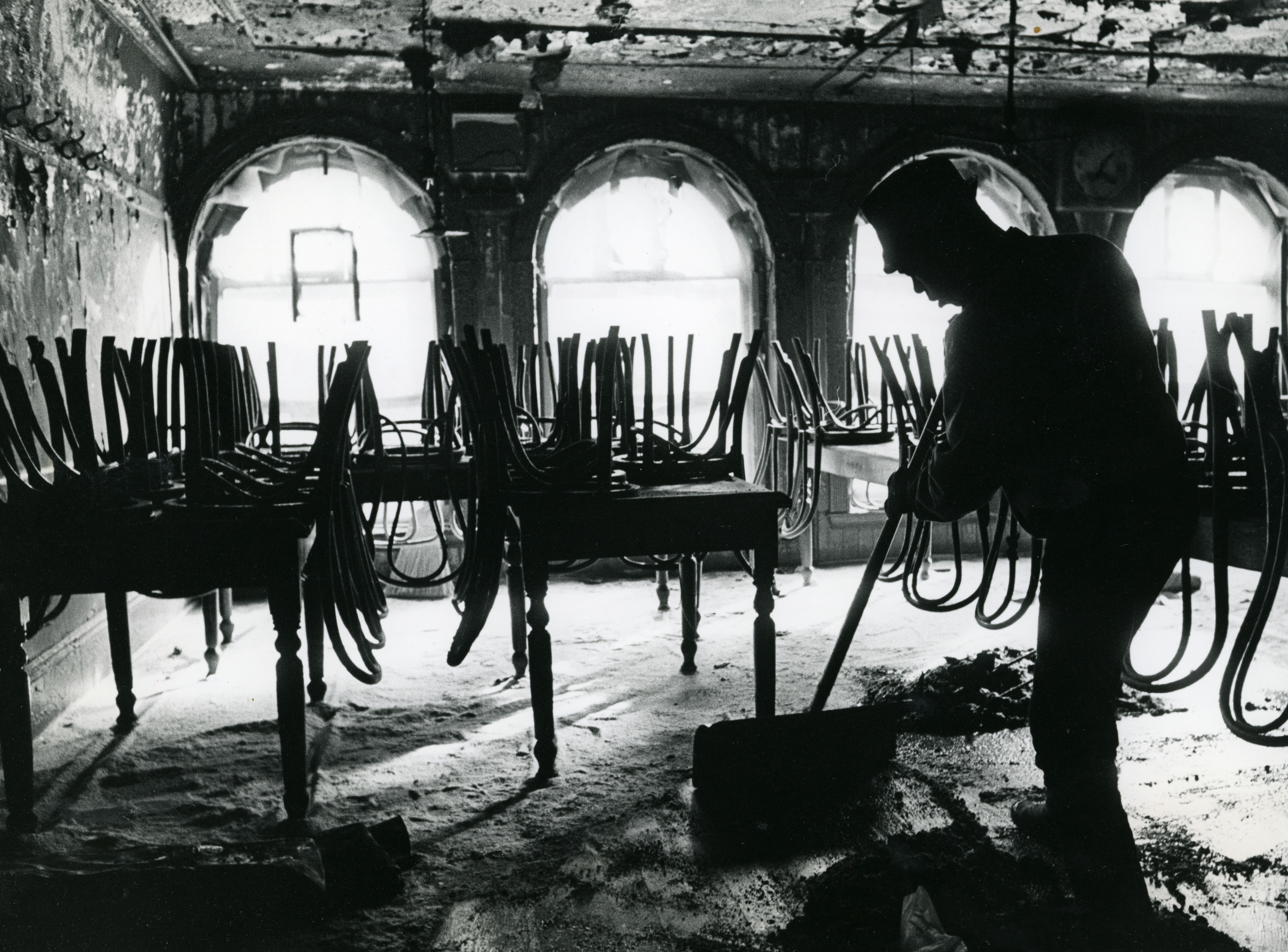 A person cleaned the inside of the burned dining room of Durgin-Park after a fire Feb. 7, 1968.