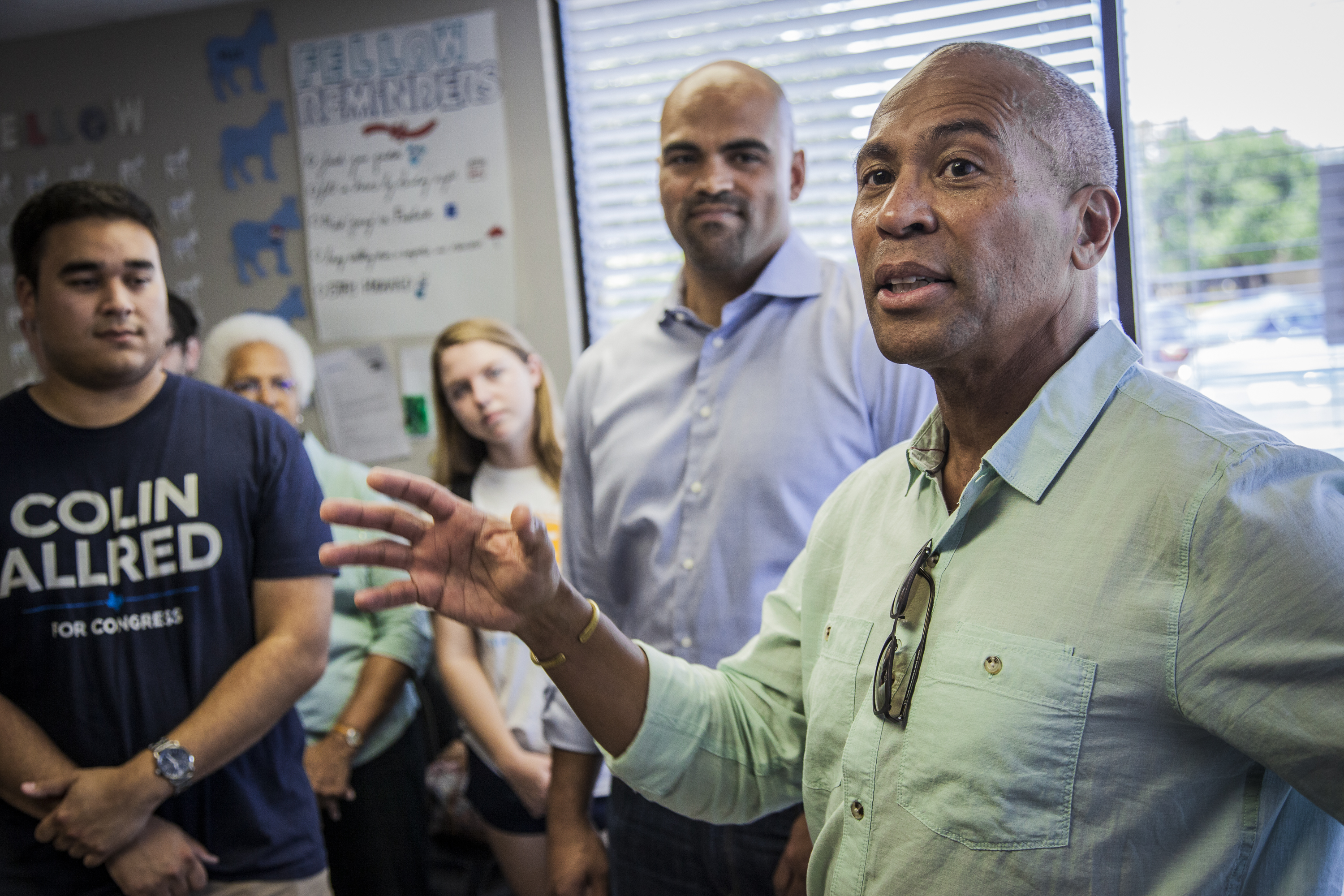 Former Massachusetts Governor Deval Patrick campaigns for Colin Allred (background center).