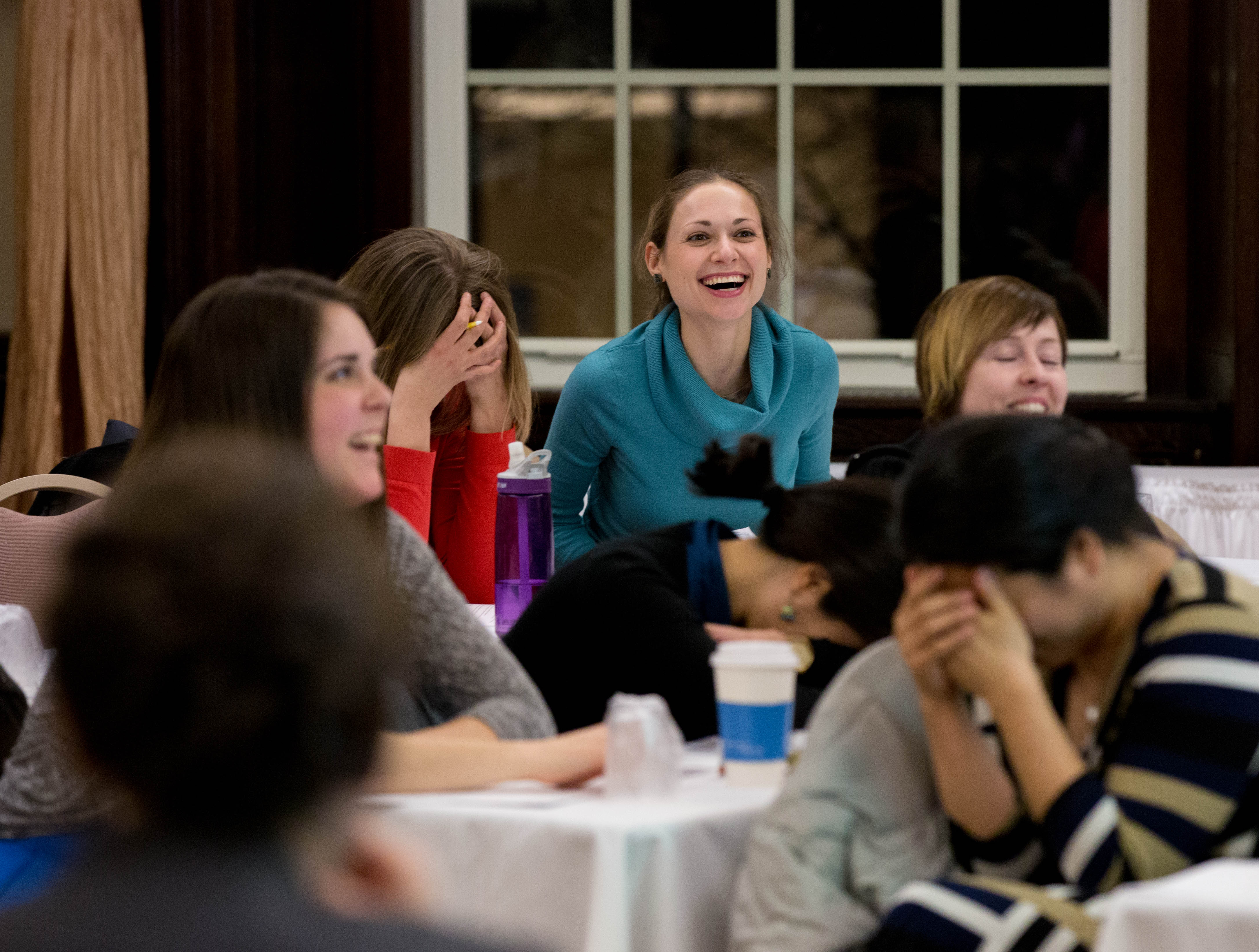 Asya Troychansky and other attendees share a laugh during the salary negotiating workshop at the YWCA.