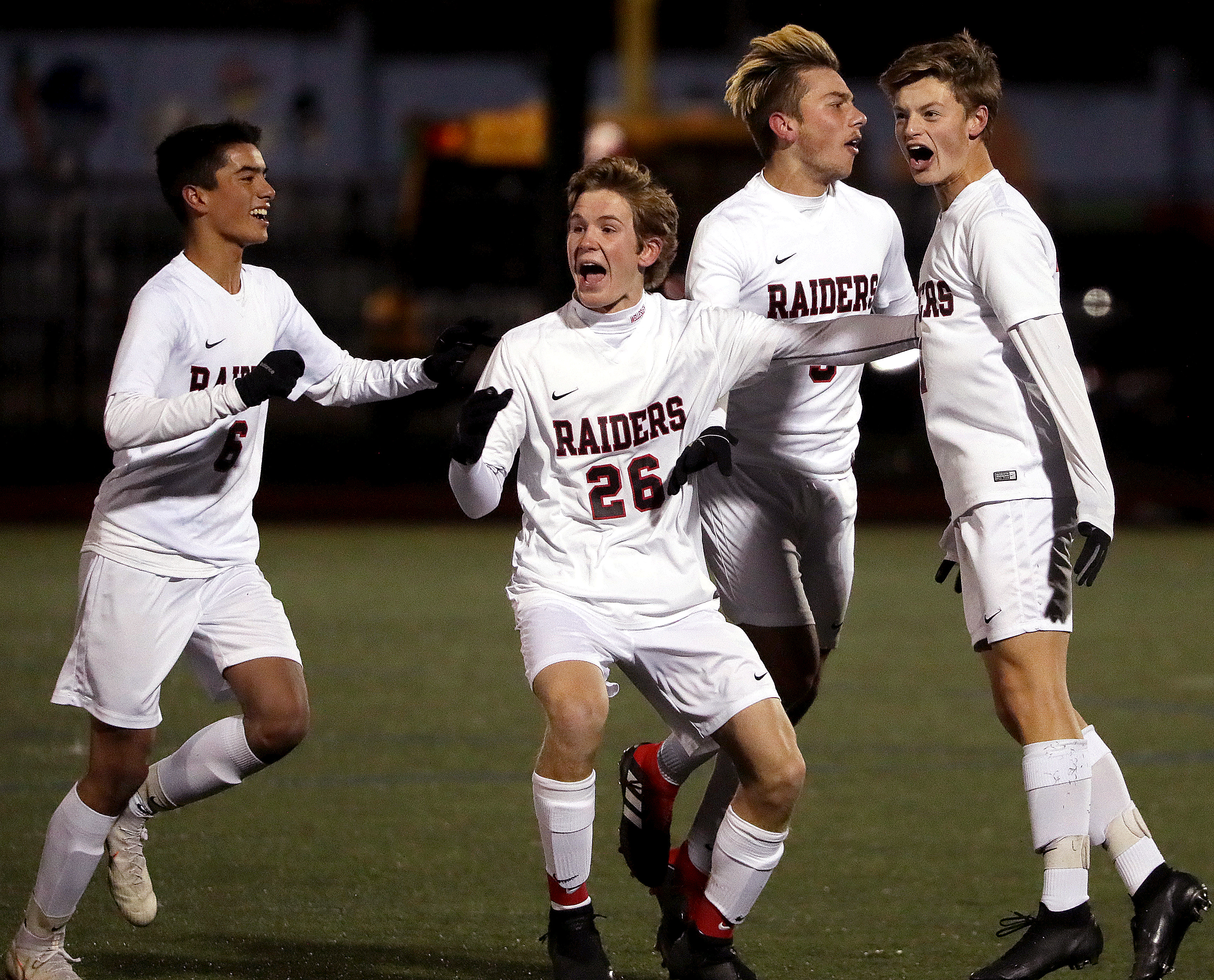 Wellesley's Oskar Haeberlein (11), far right, celebrates the first goal of his hat trick. “I was really nervous coming into this game, but then I just let go.”