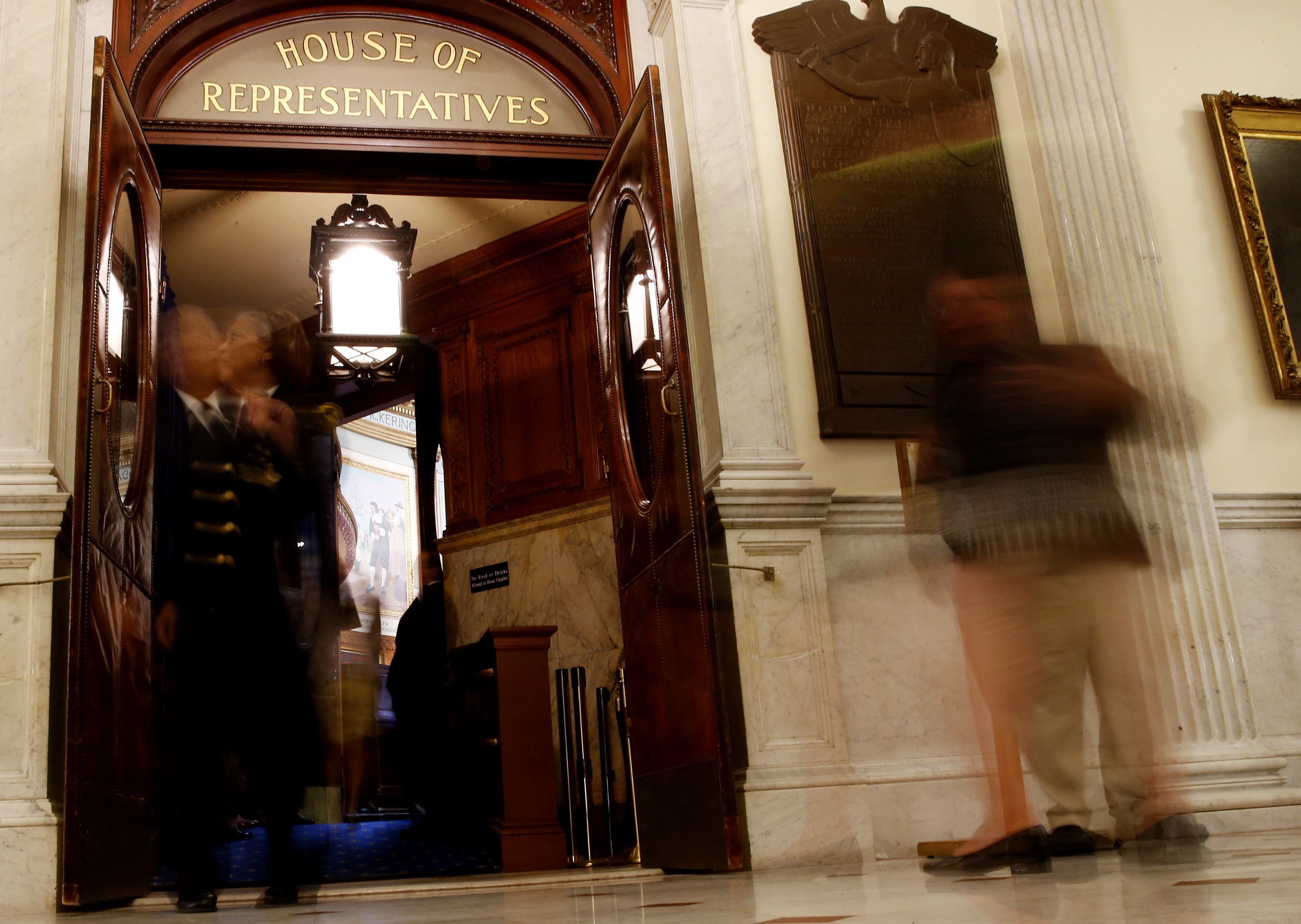 A woman called out roll call as lawmakers stream into the House of Representatives on the last day of the Legislative session at the State House.