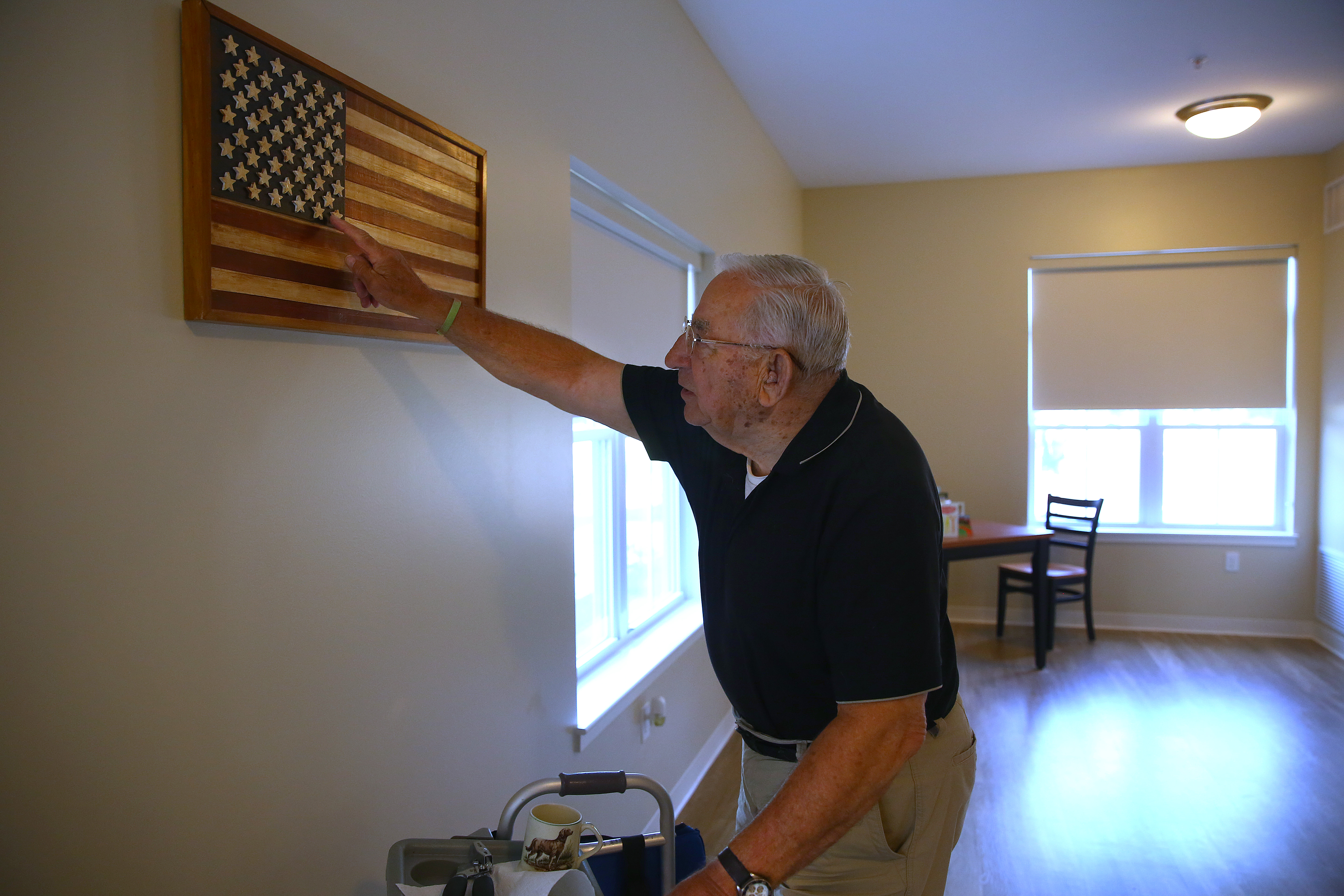 World War II veteran Michael Kaminsky, 90, cherishes the wooden flag he received about 45 years ago from a group of high school students.