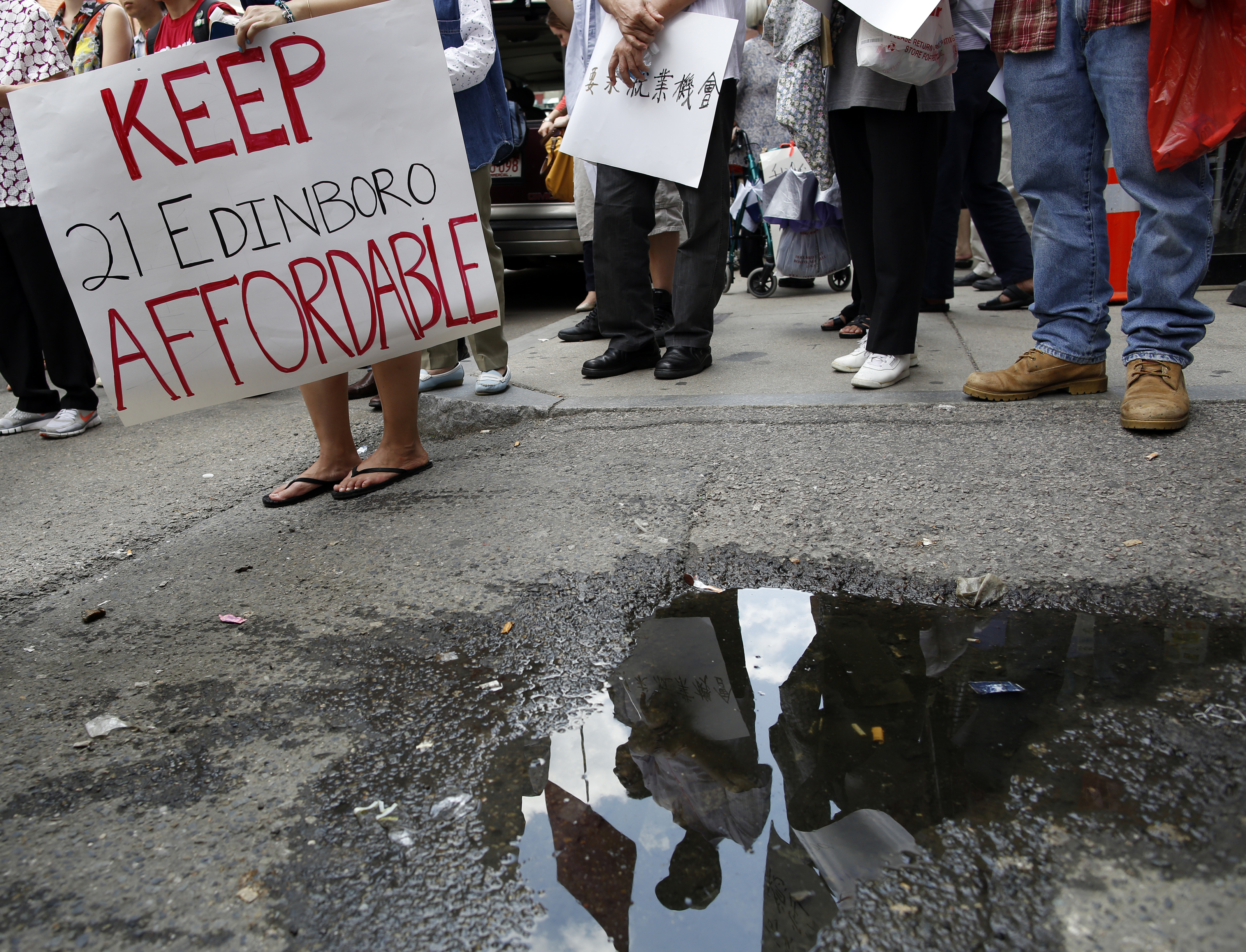 Protesters called attention to worries about the end of affordable housing in Chinatown, where developers are building new luxury apartments and residents are becoming casualties of increased property values and rents.
