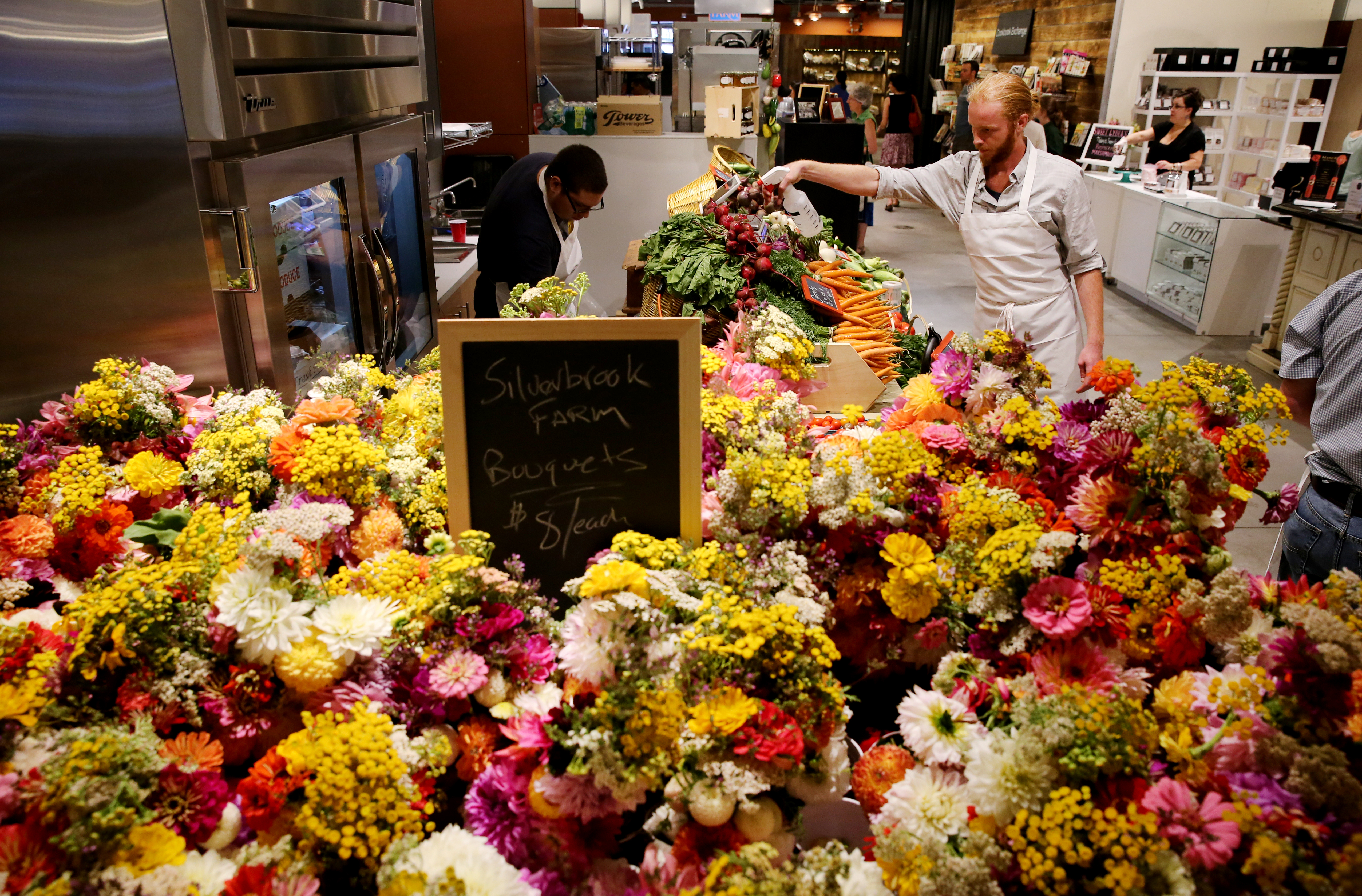 John Gray-Storey misted the vegetables at Silverbrook Farm’s stall at the newly opened Boston Public Market.