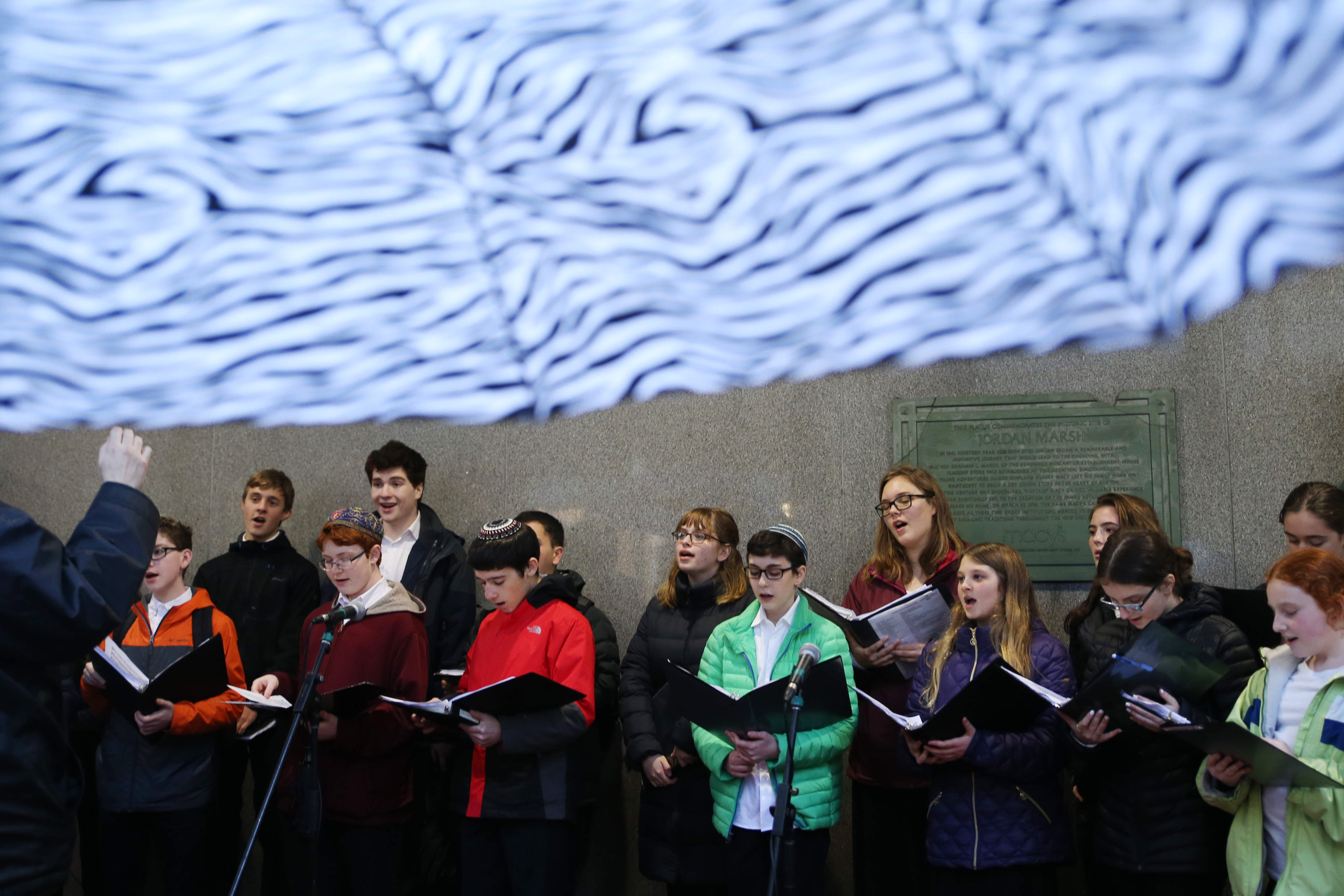 Members of HaZamir, a Jewish teen choir, performed songs outside of Macy’s before a menorah lighting at Downtown Crossing on Sunday.