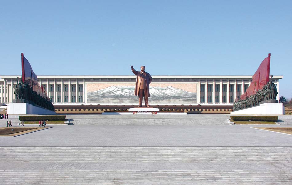 A colossal statue of the Great Leader, Kim Il Sung, dwarfs visitors to the Grand Monument on Mansu Hill.