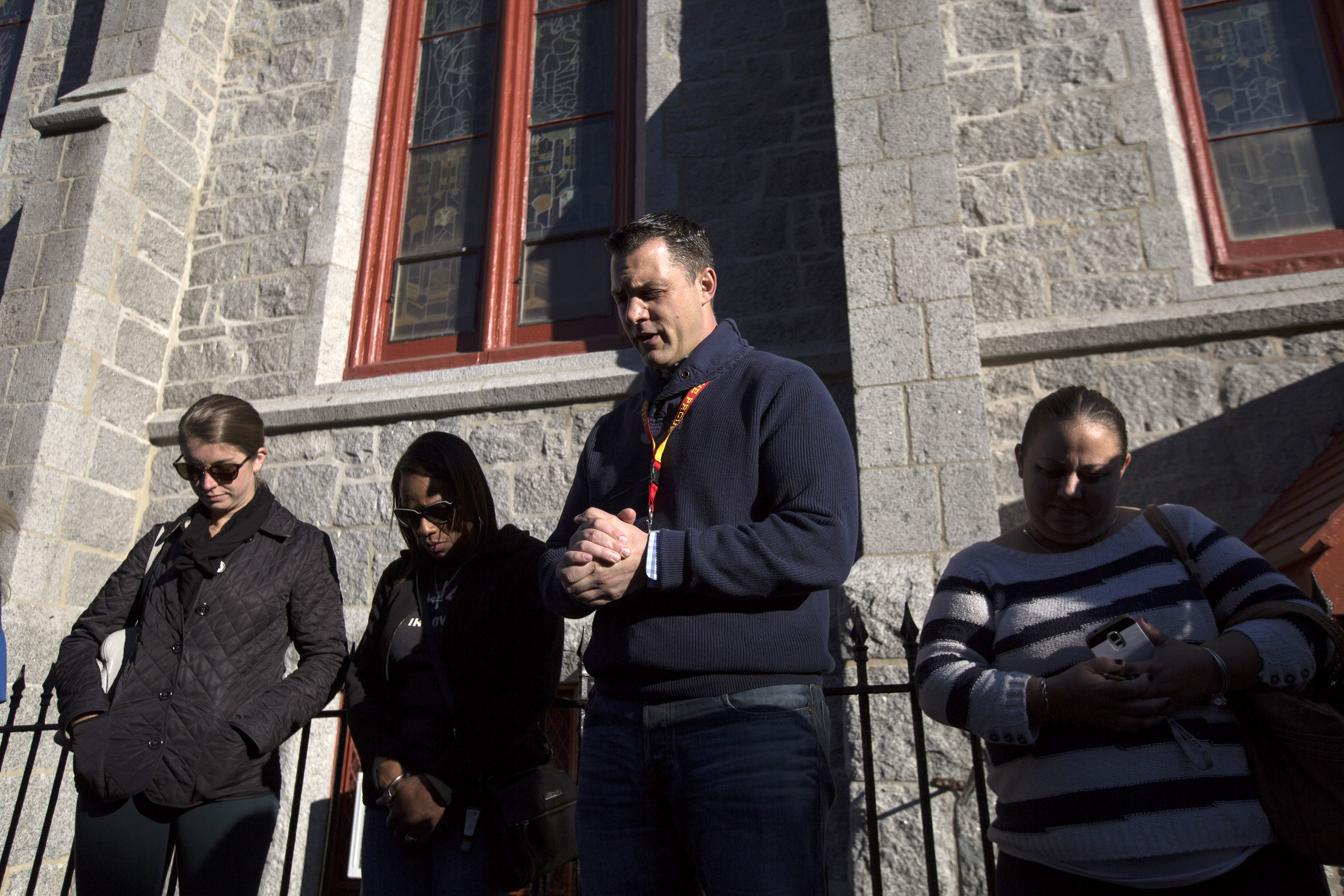 Chaplain Joseph Logrippo (center) led East Boston residents and members of the police force in prayer before a peace parade through the neighborhood on Oct. 15.
