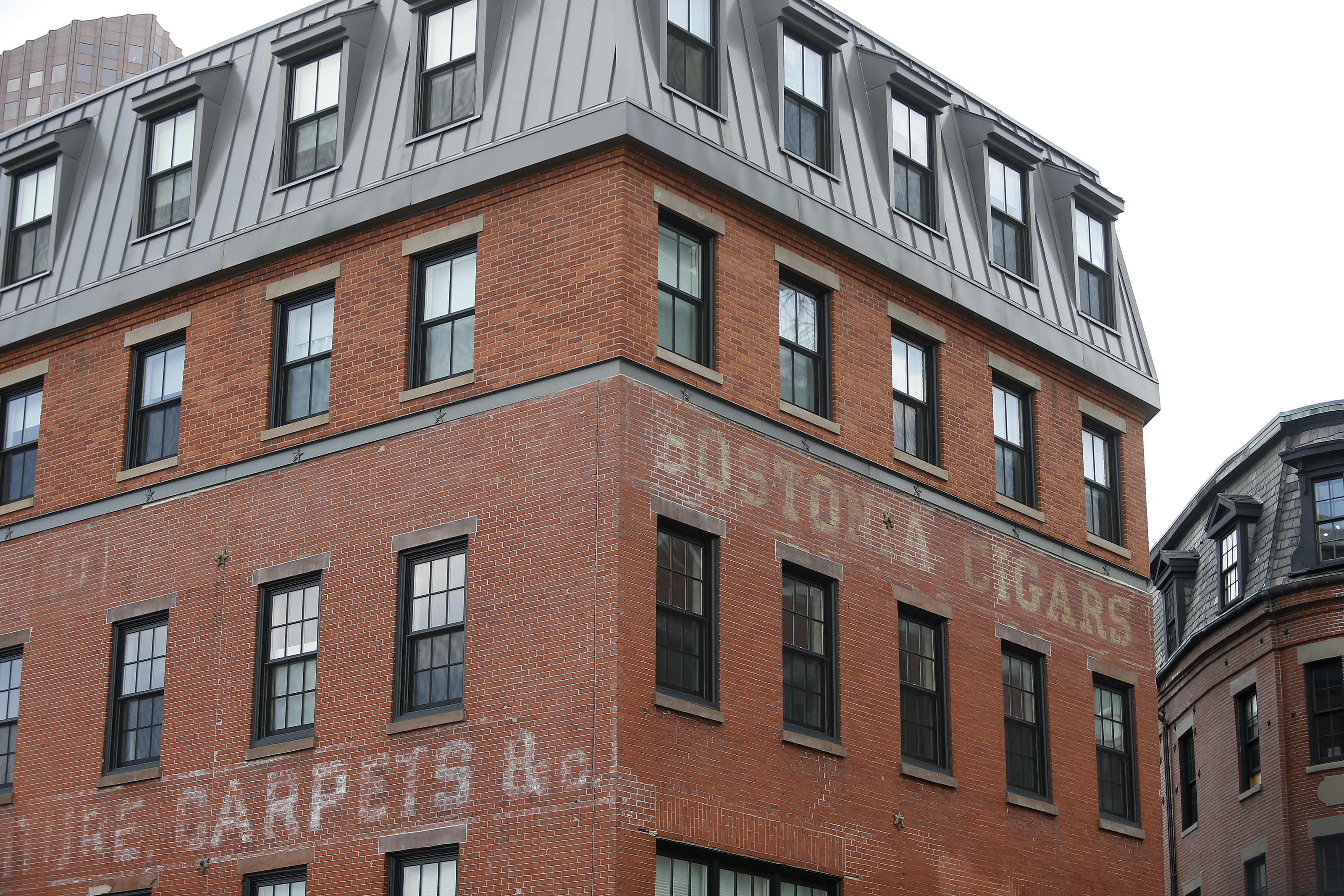 Ghost signs fade into the brick of this building on Blackstone Street.