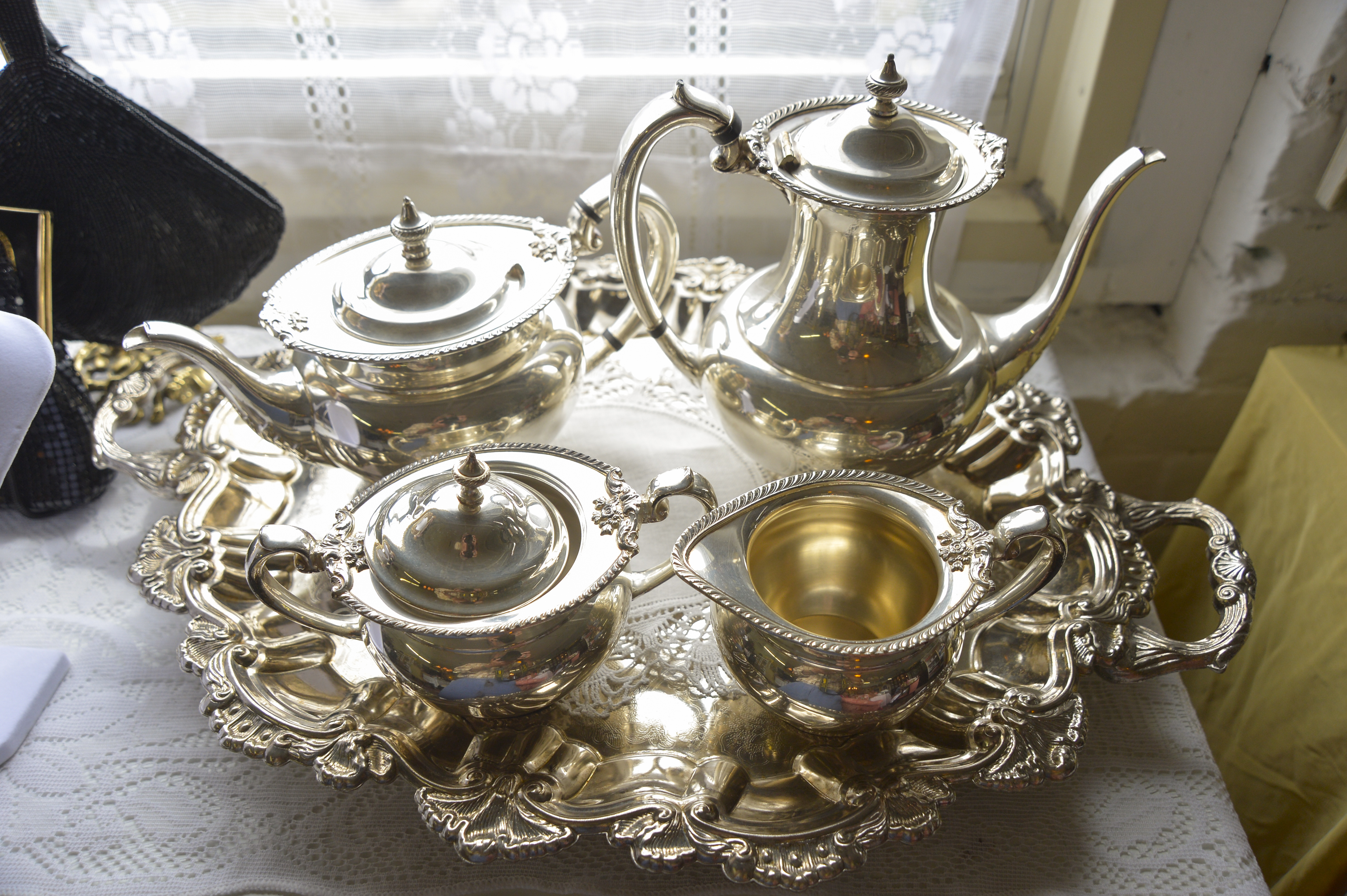 A silver tea set sits in a window by a customer's table at Suzanne’s.