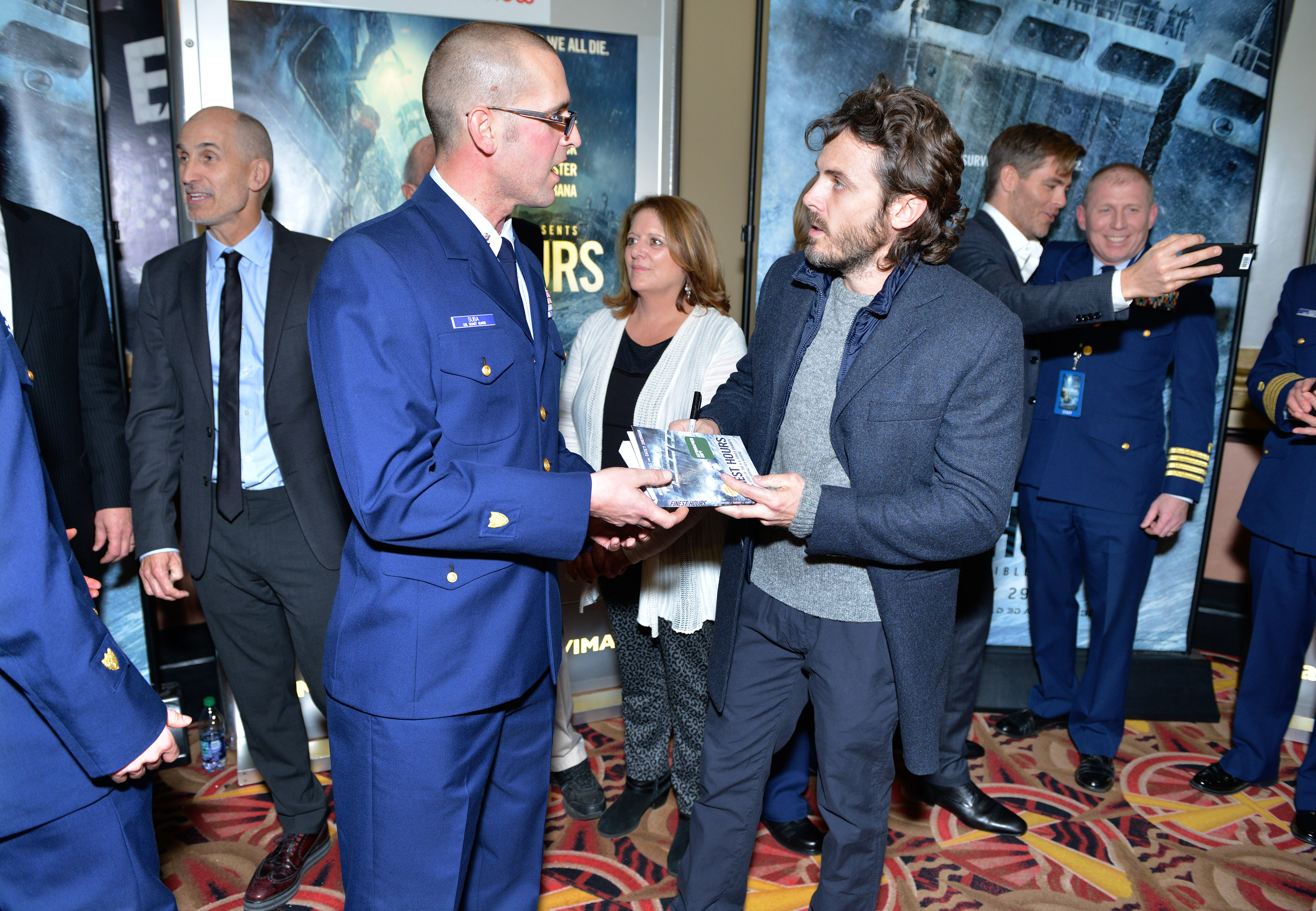 Casey Affleck signed a book for Coast Guard Petty Officer 2nd Class Derrick Suba.