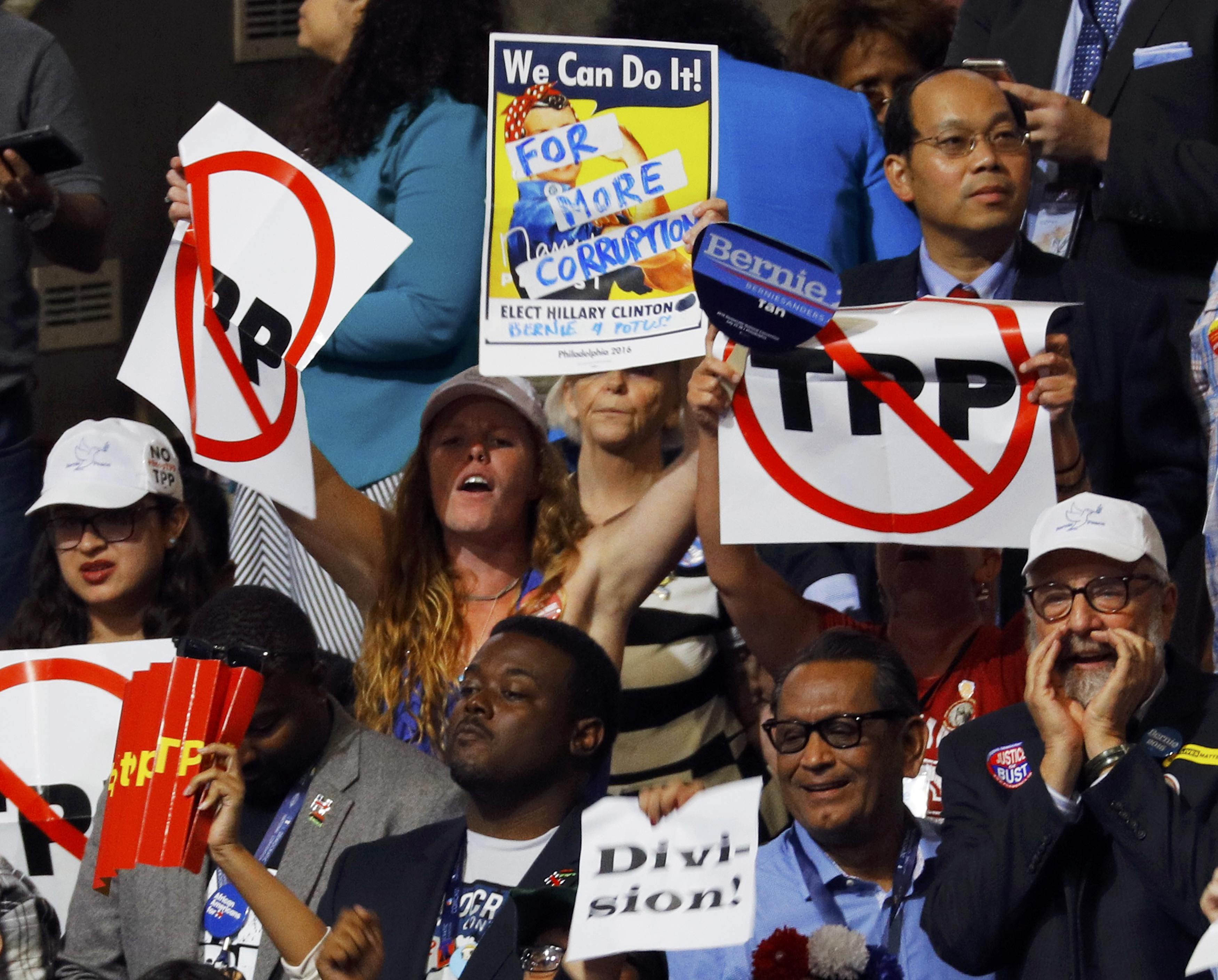 Delegates protesting against the Trans Pacific Partnership trade agreement held up signs during the first sesssion of the Democratic National Convention in Philadelphia.
