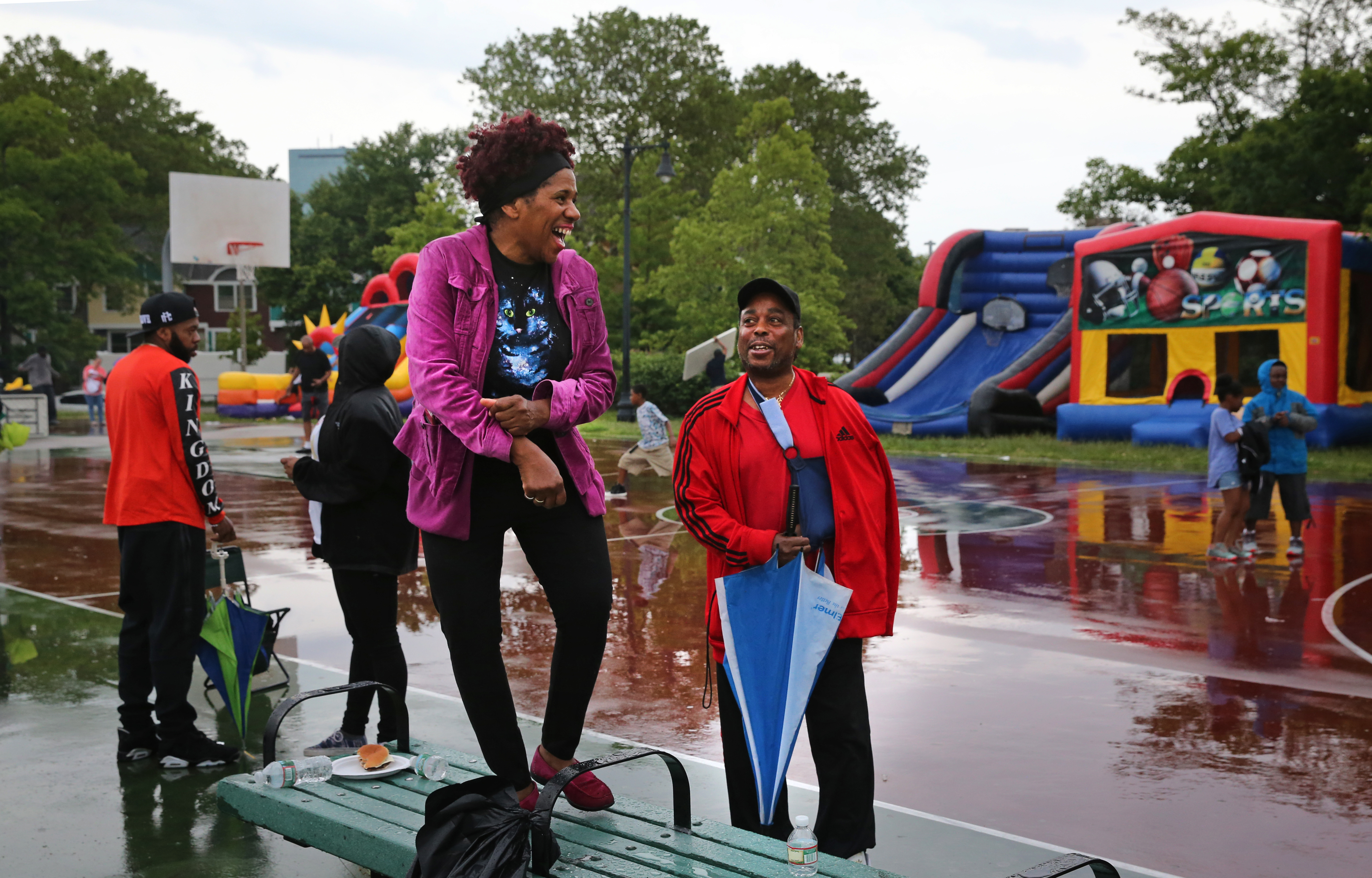 Longtime Madison Park Village resident Pam Cannon danced on a bench and talked with Wayne Price during Unity Day at the development.