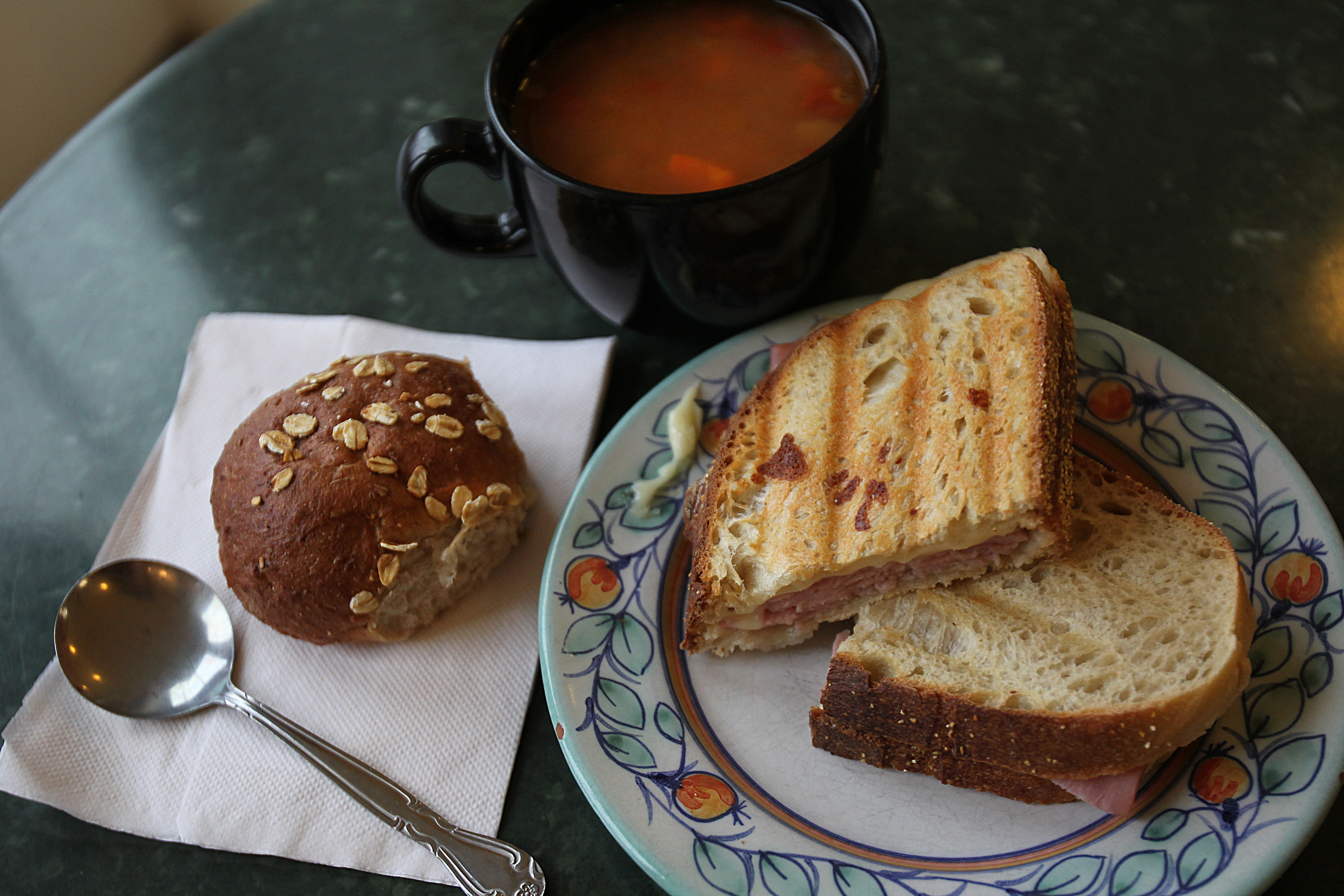 Ham and cheese panini with cup of soup.