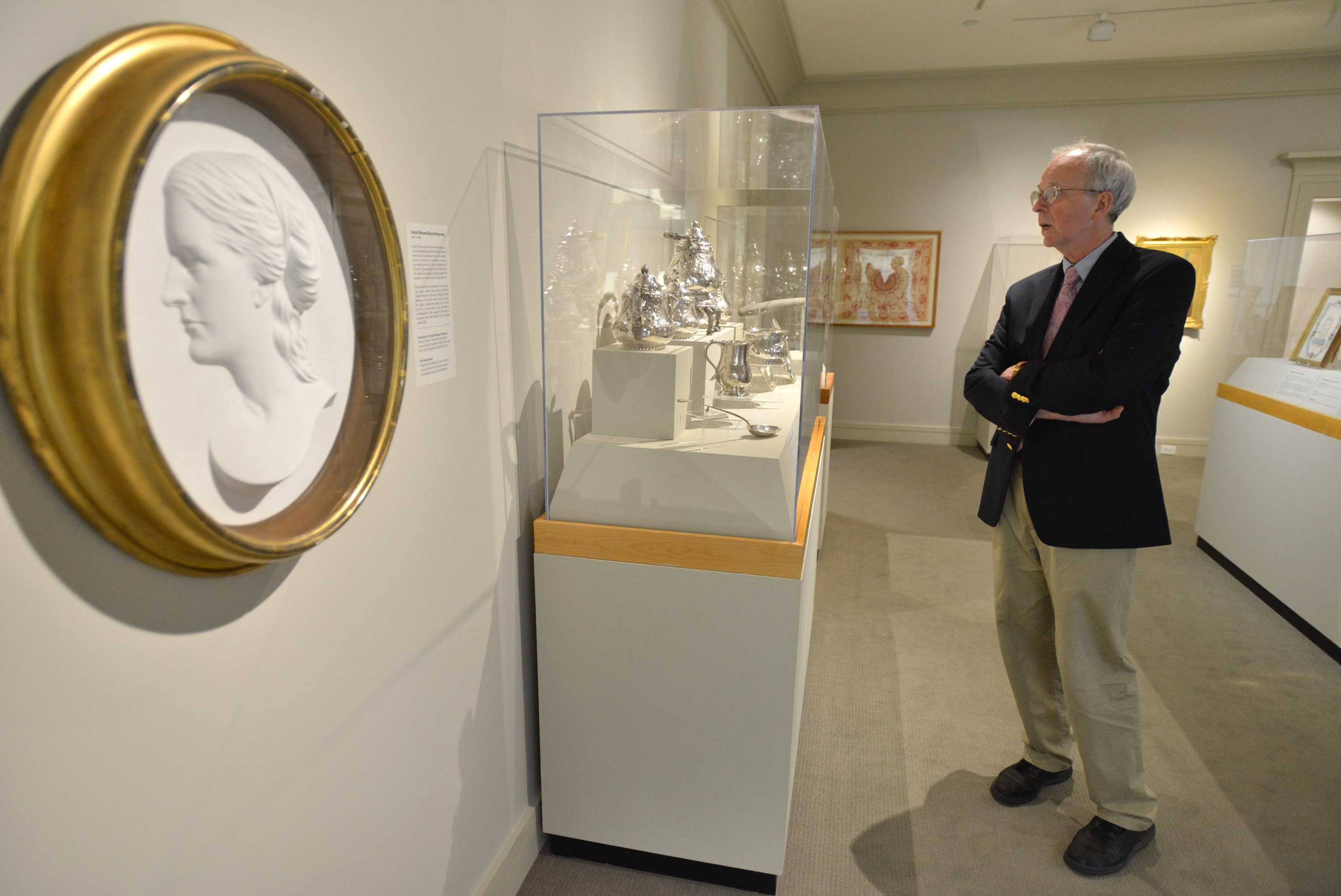 Curator David Wood admires a silver tea service owned by Rebecca Poor Farnham, from which Ralph Waldo Emmerson would often have been served. In the forground is a portrait of Emerson’s wife, Annie Shepard Keyes Emerson.