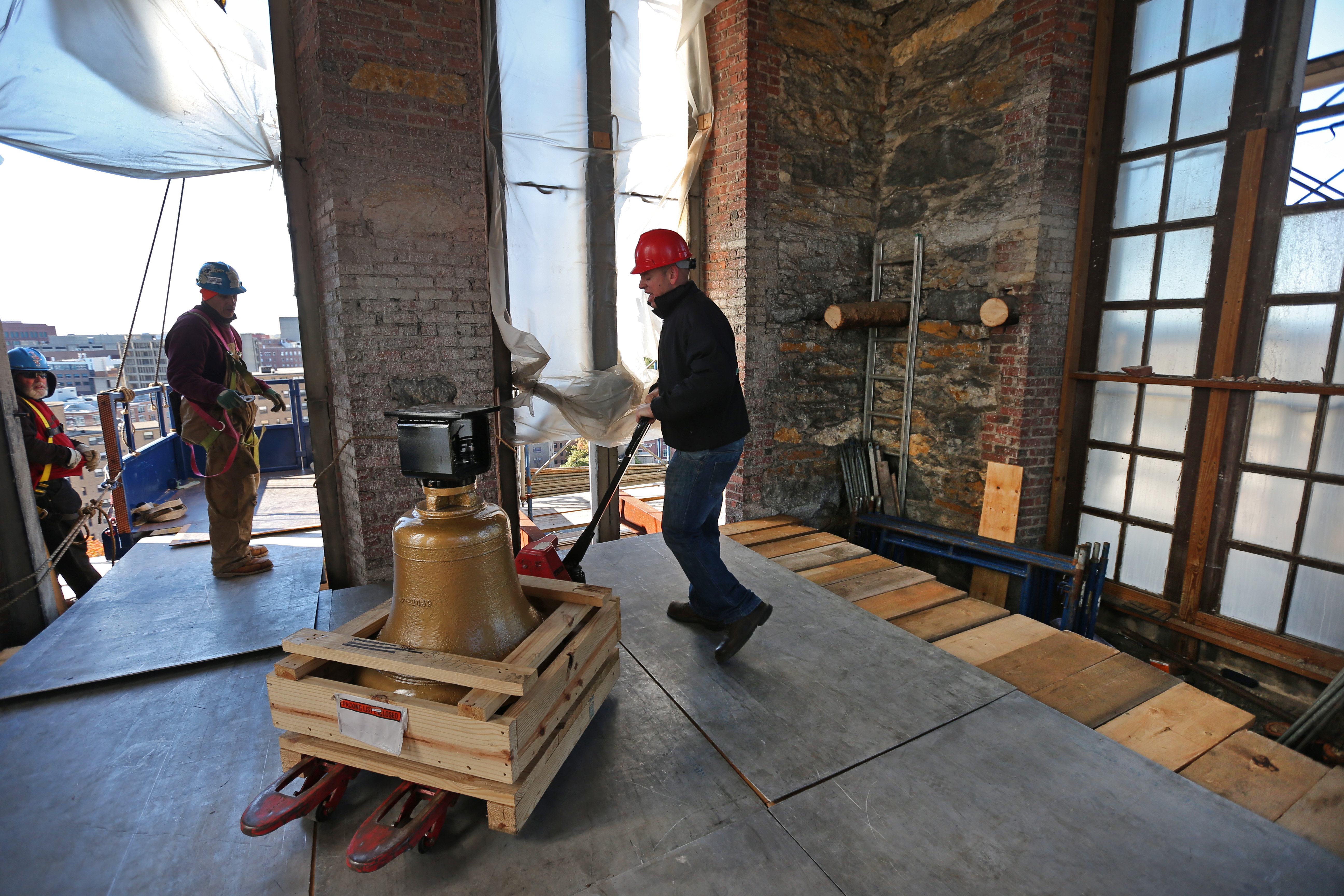 Patrick Folan Jr. placed a bell on the tower floor.
