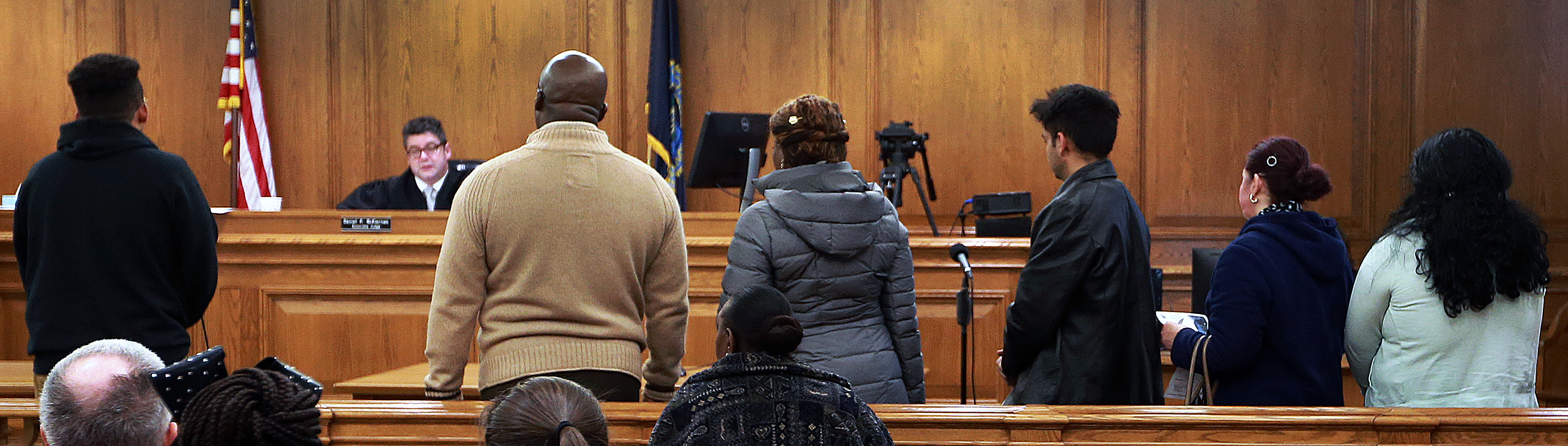 Defendants waited their turn to appear before Judge Daniel P. McKiernan.