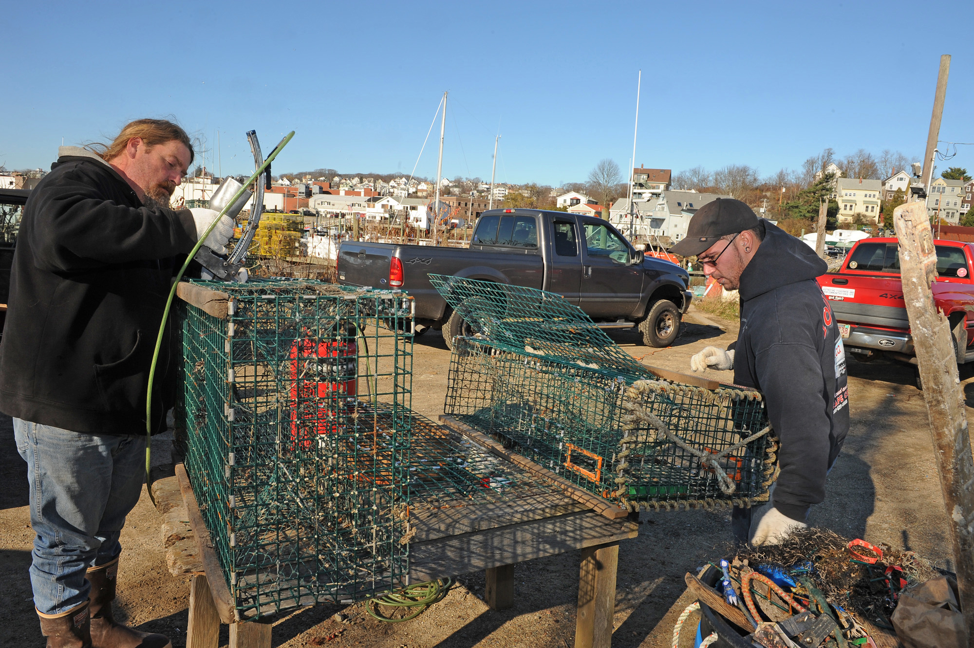 In this photo taken in December 2011, David Sutherland (left) known as Heavy D, and Stephen Redefern repaired steel lobster traps for the fishing boat Trapper Johns at Capt Joe's and Sons in Gloucester, Mass.