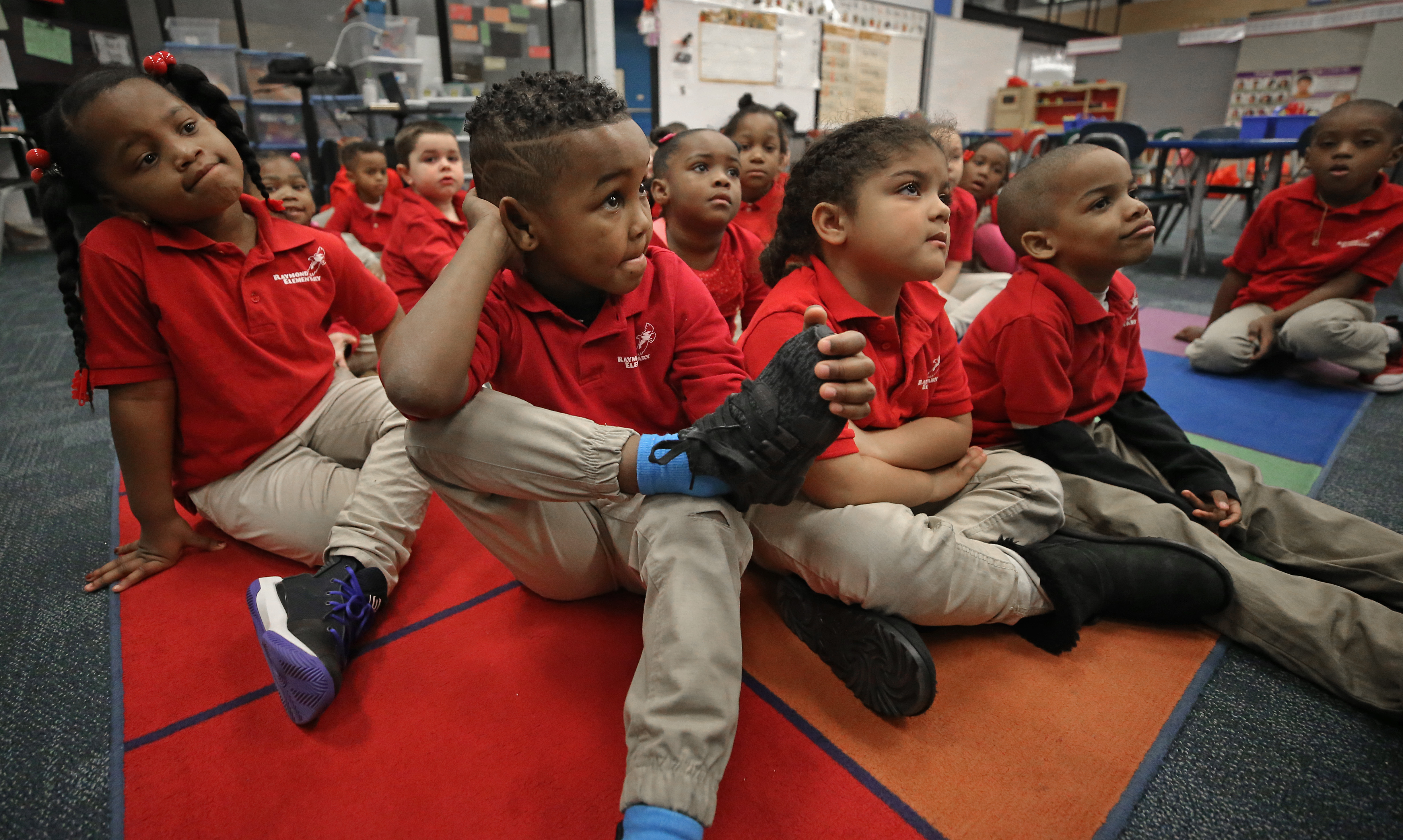 Kindergarten student Leonel Monteiro crossed his legs in teacher Amy Mazzola's class and listened to readings.