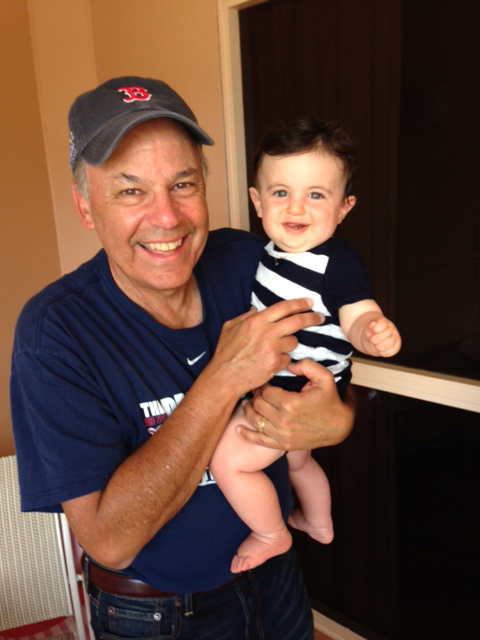 The meteorologist holding his youngest grandchild, Henry.