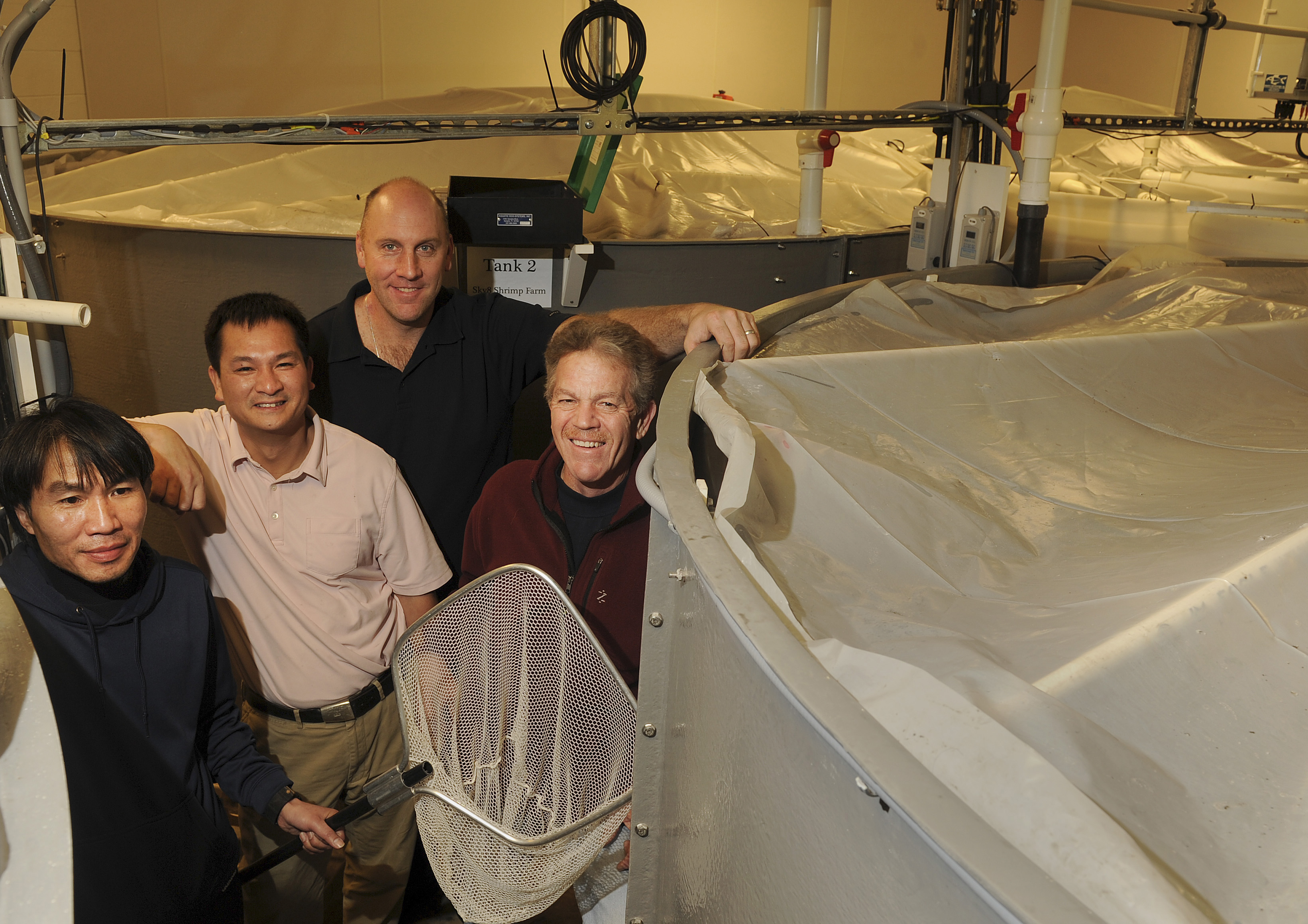 At the farm, from left: operation manager Tone Lovan, James Tran, James Devine, and Peter Howard. Tran and Howard are Sky 8’s co-owners.