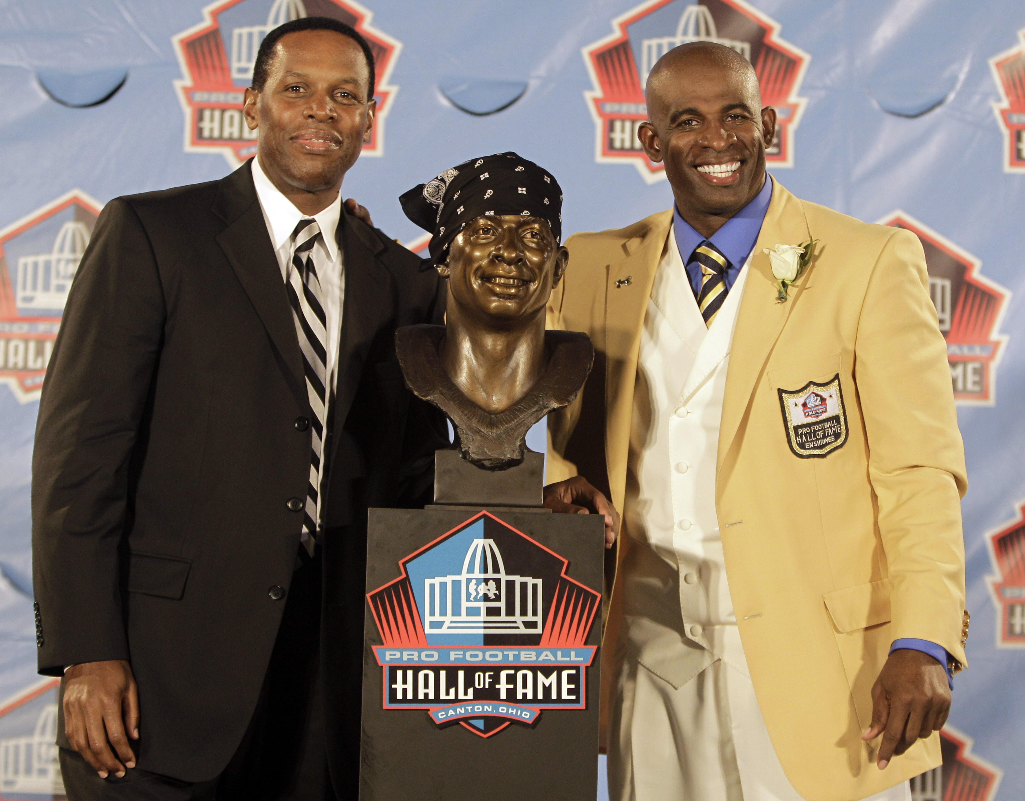 Eugene Parker (left) posed with client Deion Sanders during Sanders’ induction ceremony at the Pro Football Hall of Fame in 2011.