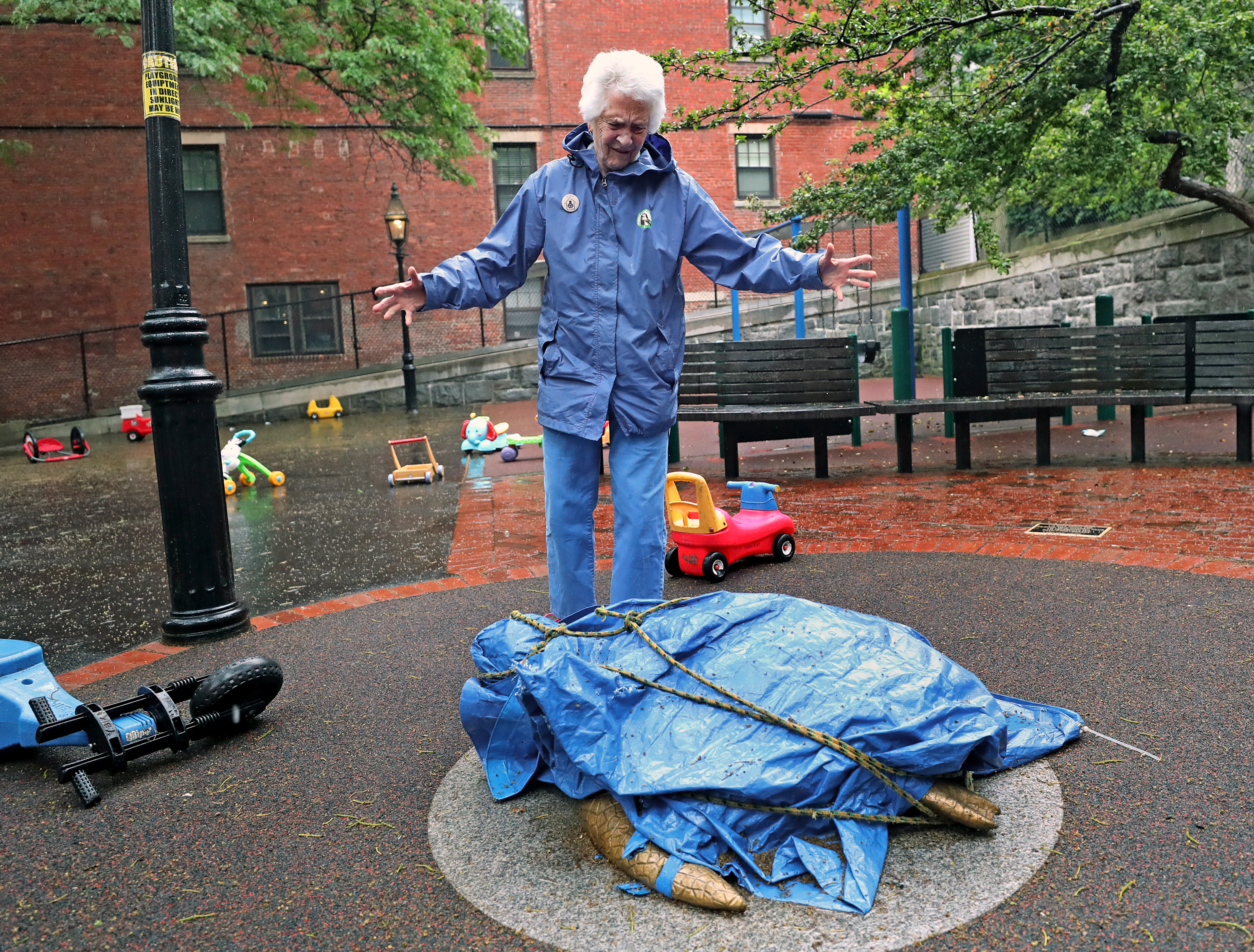 Sculptor Nancy Schon viewed her sculpture covered up by a blue tarp at the Myrtle Street Playgound.