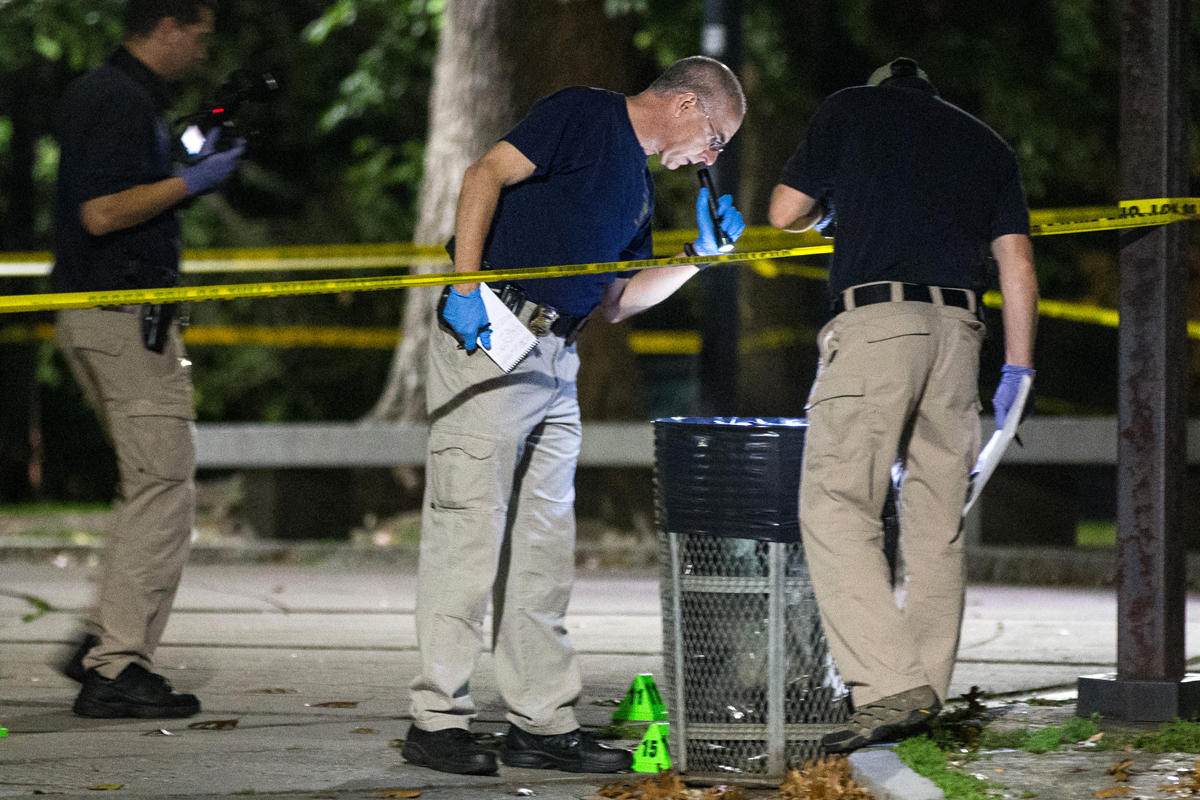 Investigators checked a trash can at Boston Common following the stabbing of two park rangers.