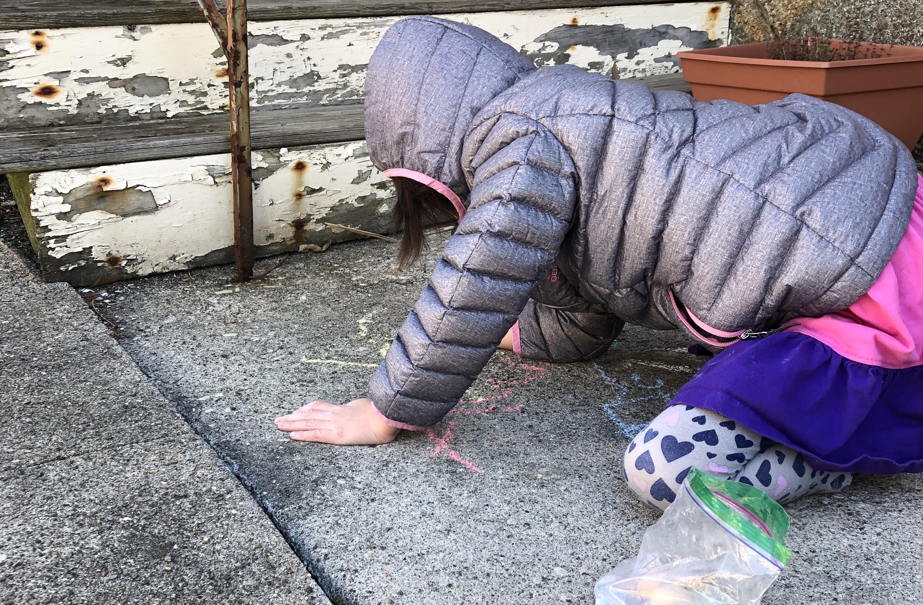 Audrey Stott, 5, leaves a chalk-written note for a friend in Jamaica Plain.