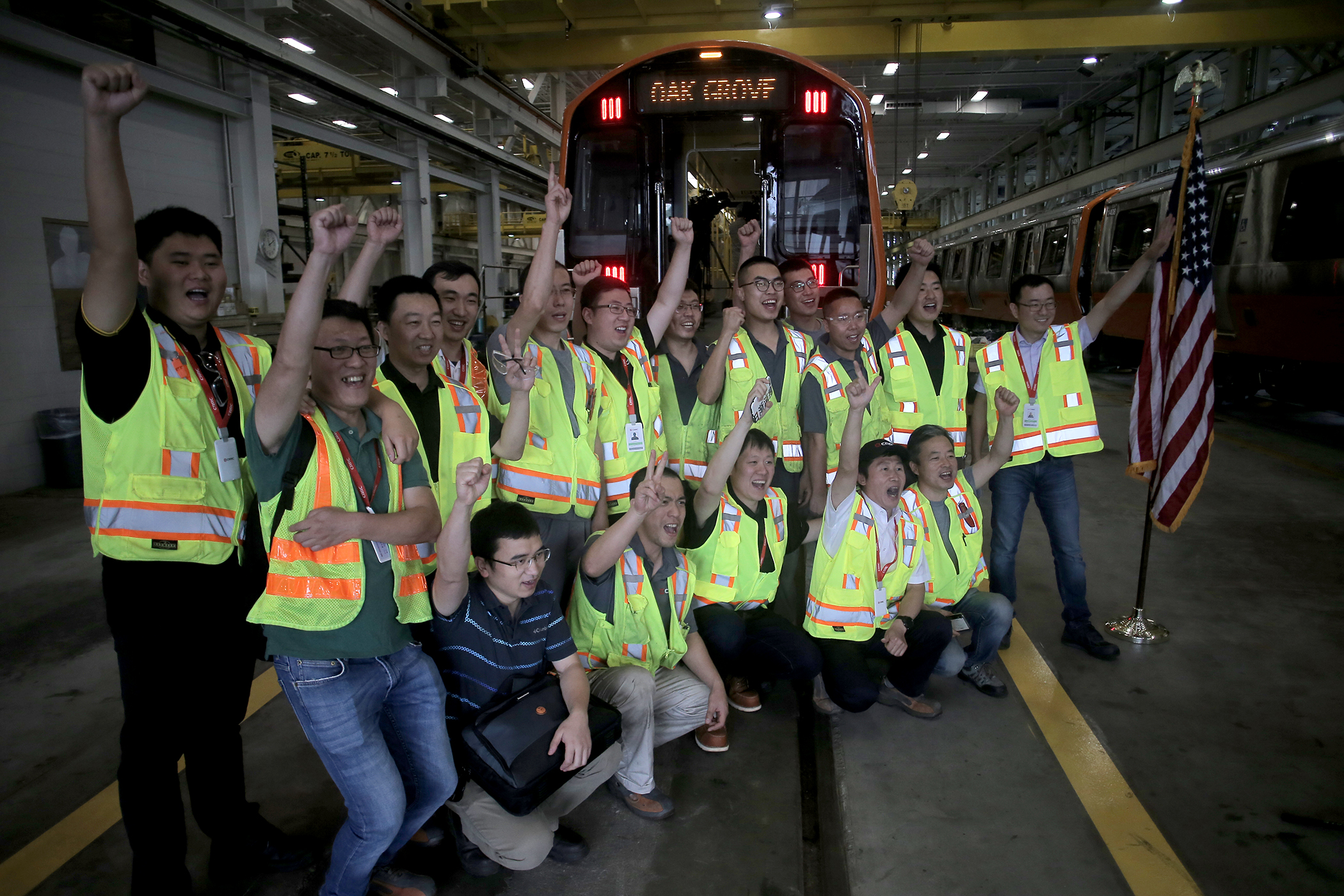 Employees of Chinese manufacturer CRRC gathered for a picture in front of a new Orange Line train.