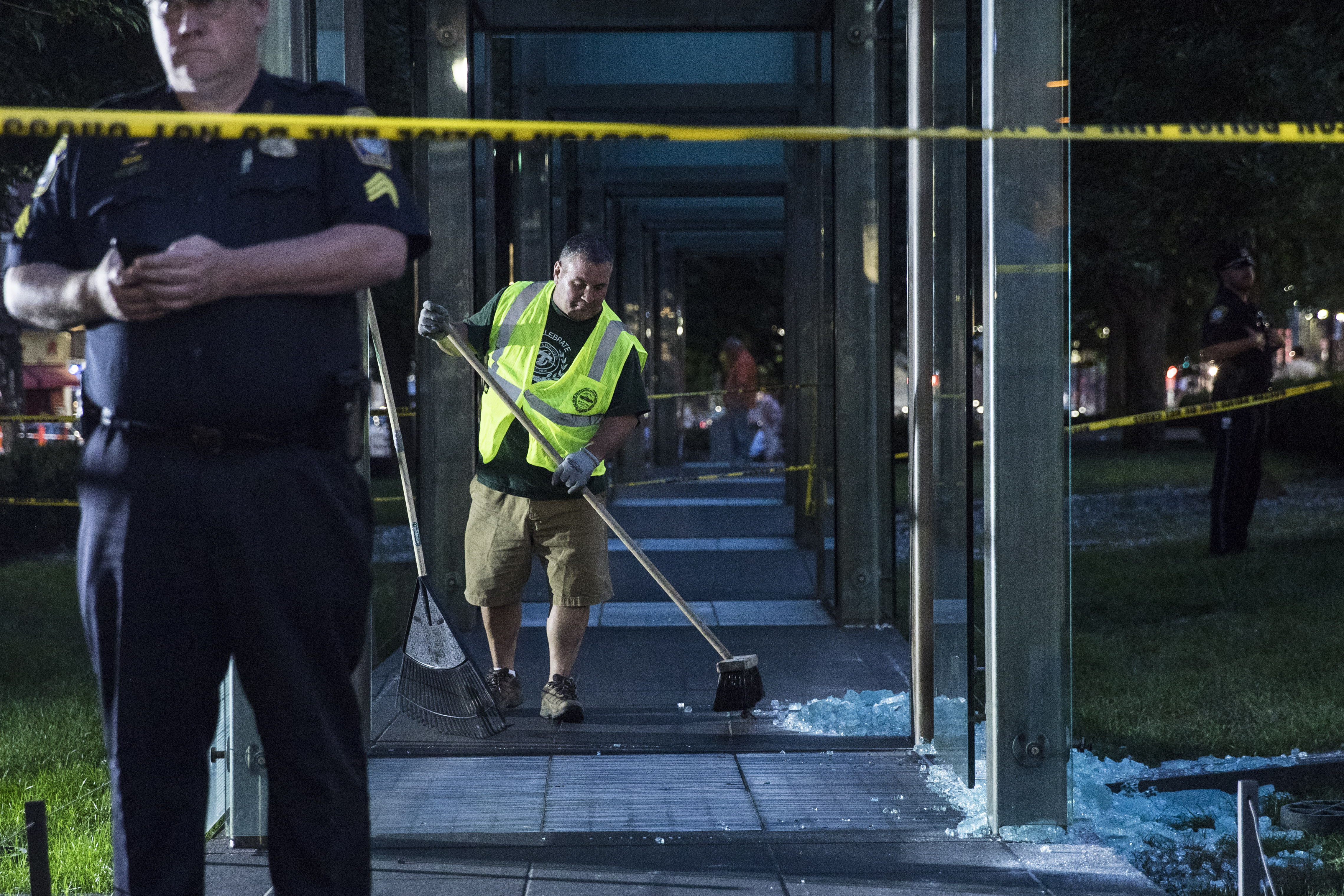 Employees cleaned up the shattered glass at the memorial.