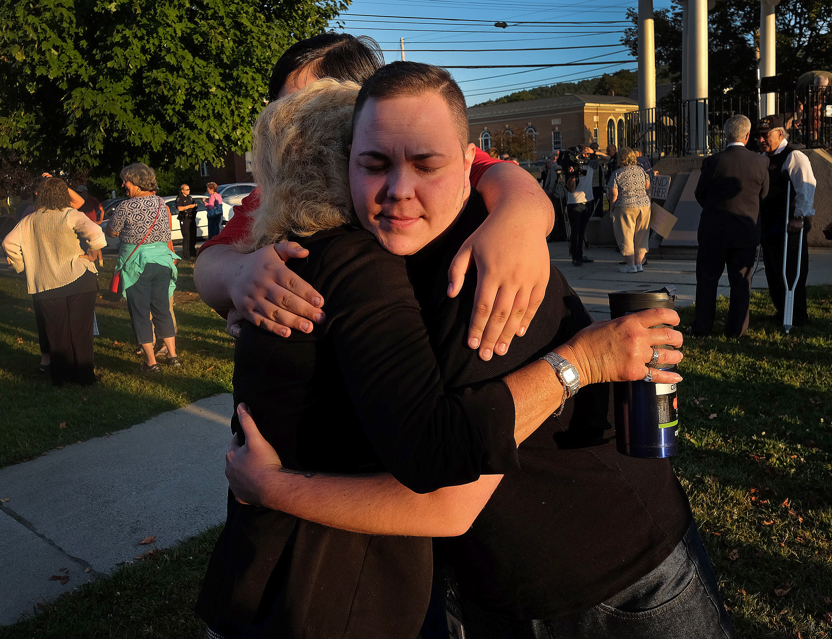 Lyrik Merlin (right), 30, hugged his mother Lorrie Slattery and his brother Nason Slattery, 16.