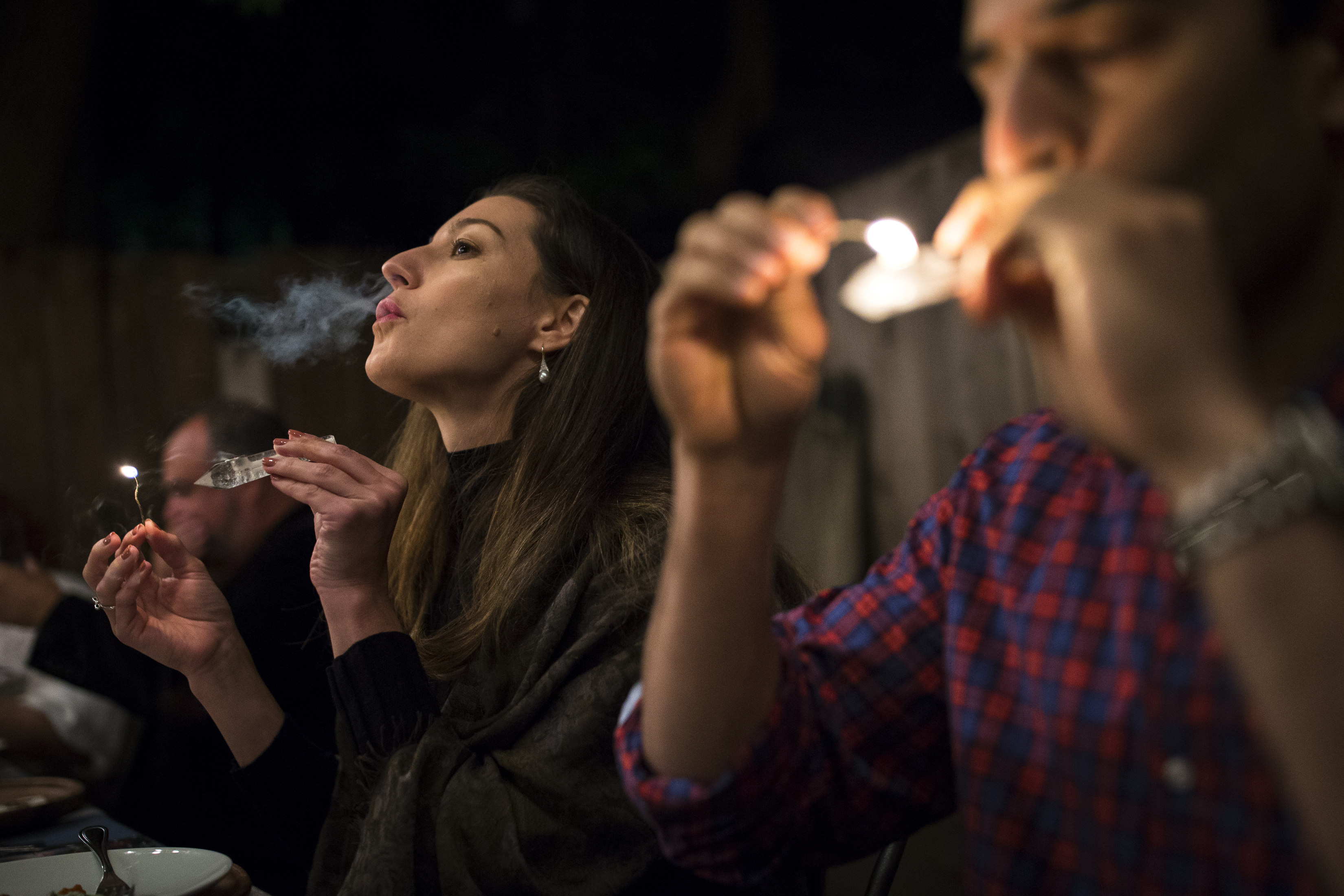 Natalie Carrier of Brookline exhaled smoke while Asim Ghaffar of Boston took a hit from a pipe at the event.